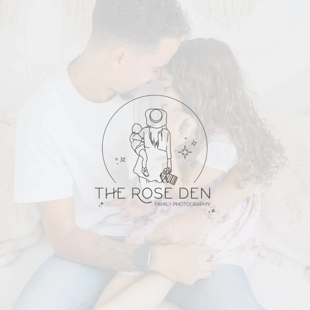 A man and woman sitting close together, with their foreheads touching and eyes closed, in a cozy setting. The woman is holding a small puppy, and the man has tattoos on his arm. Family photography logo overlay with a line drawing of a woman holding a child and a puppy, surrounded by stars and sparkles.