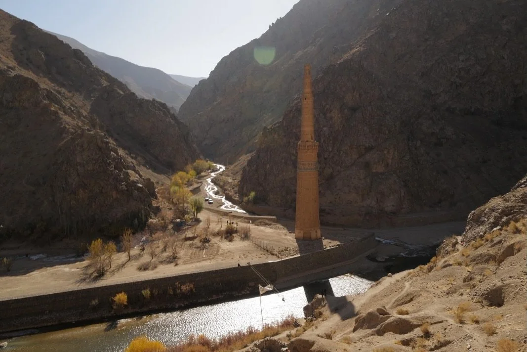 Weaving through the remote and rugged valleys in Ghor province in western Afghanistan, a dramatic scene appears. Rising from the confluence of the Hari and Jam rivers, a solitary tower reaches skyward, as though summoned by the surrounding mountains 