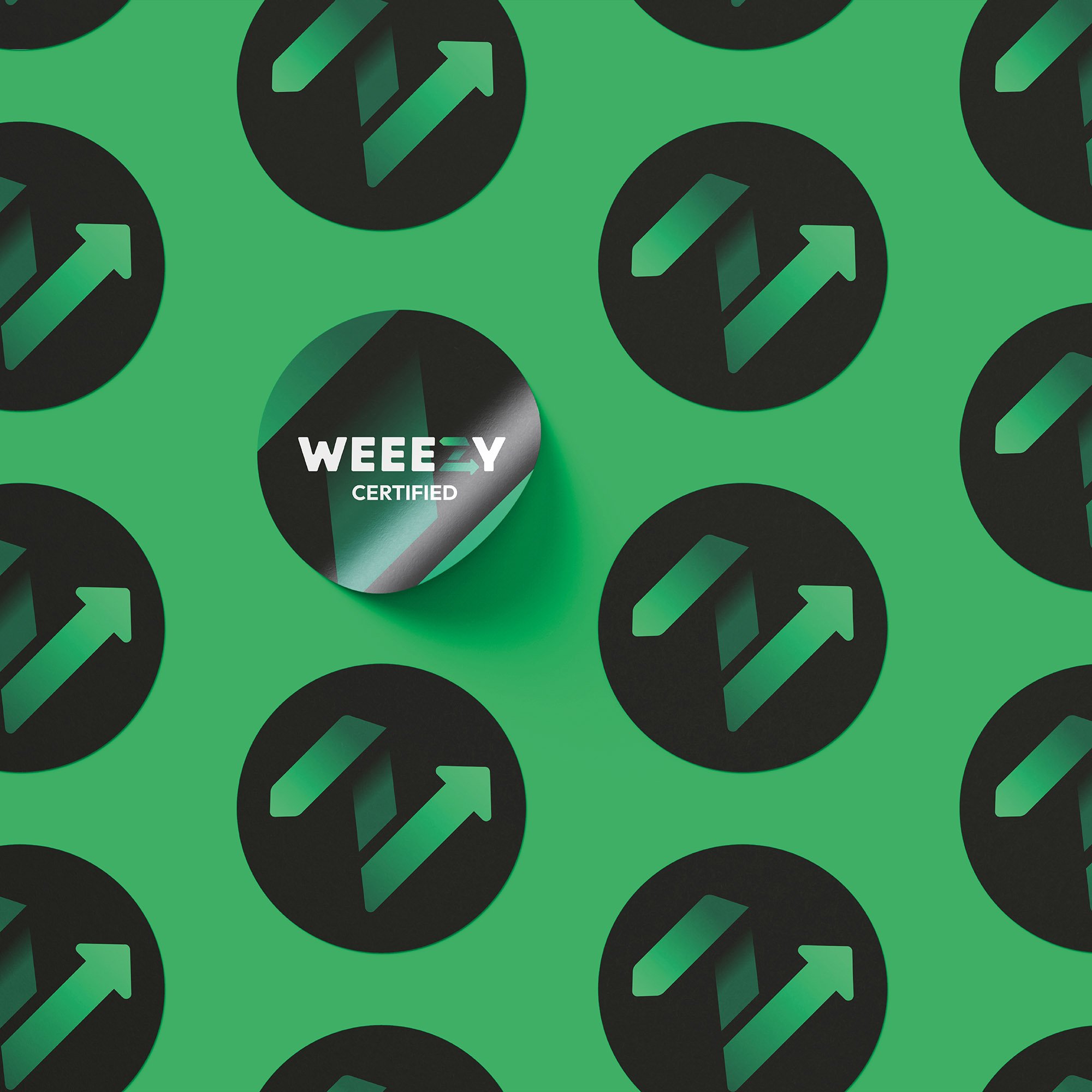 Weeezy green z arrow graphic placed on black, circular stickers, on a bright green background. One sticker features the full Weeezy logo with ‘certified’ written underneath.