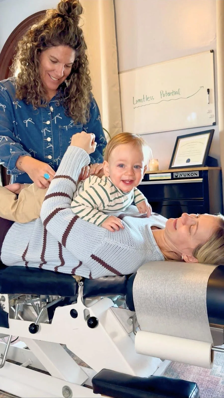 A mom and infant getting checked in Cypress Chiropractic & Wellness, downtown Charleston, SC.
