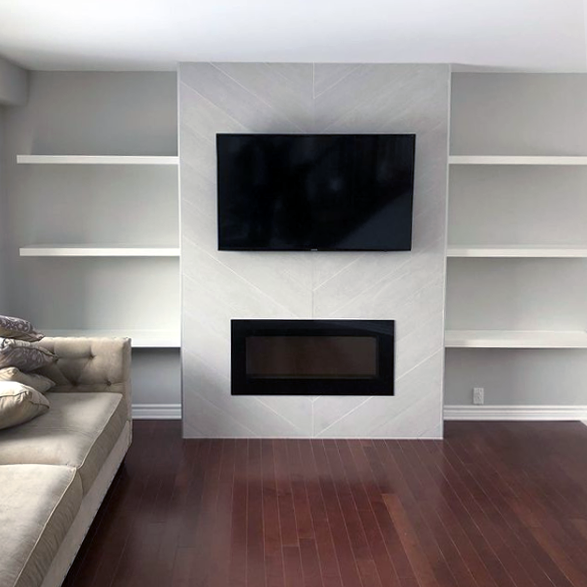 New hardwood floor, tiling, electrical fireplace and tv mount with hanging white shelves.