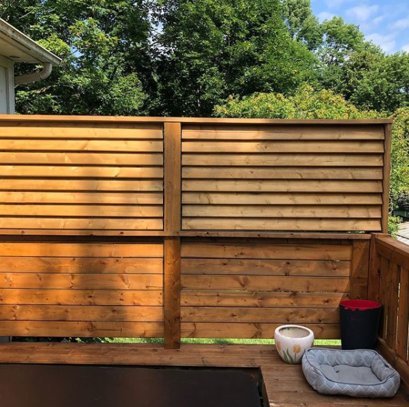 A privacy wall custom built to create a more secluded space for a hut tub, with louvred shutters.
