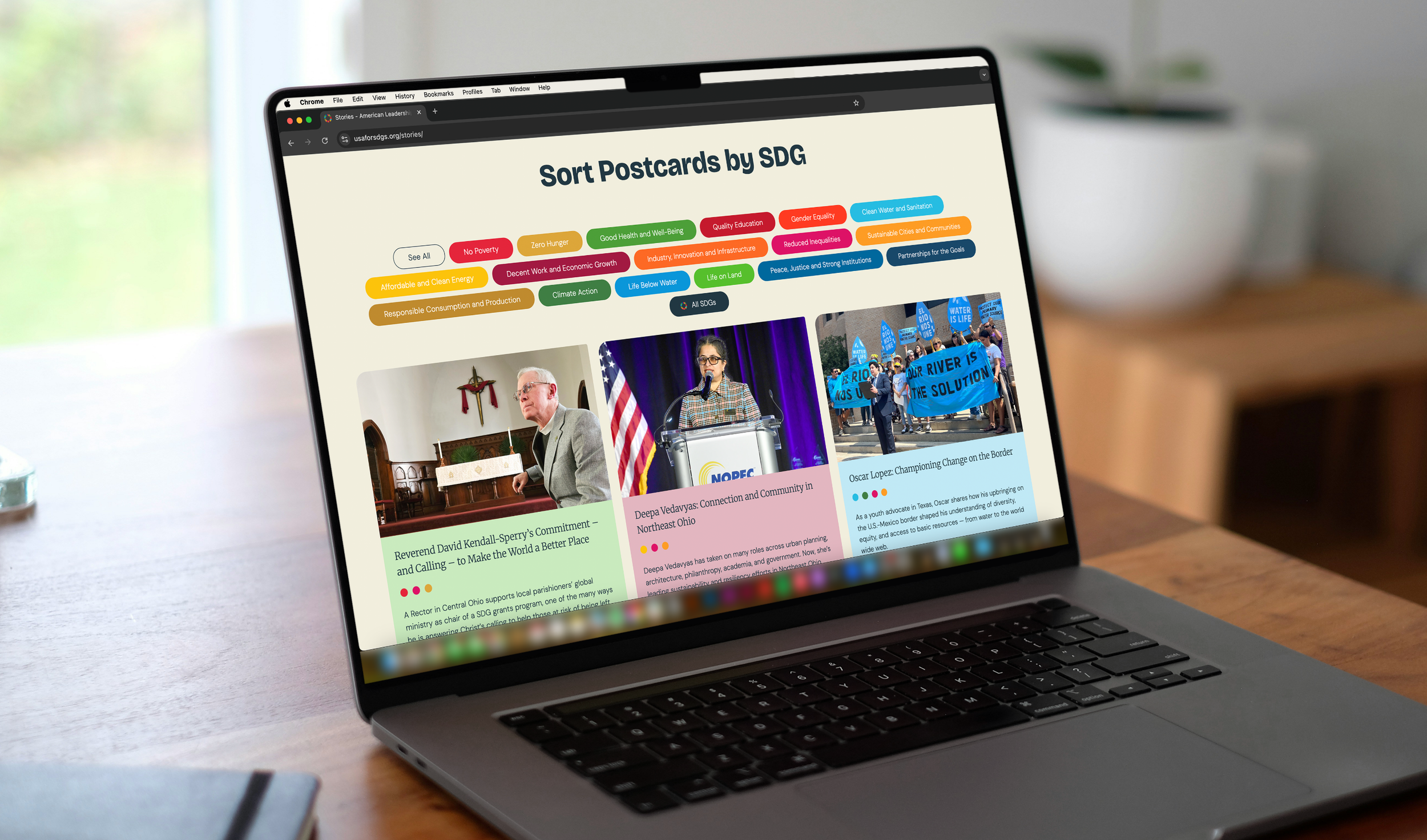 Laptop screen displaying a webpage titled 'Sort Postcards by SDG' with colorful tags representing sustainable development goals and images of people speaking at events.
