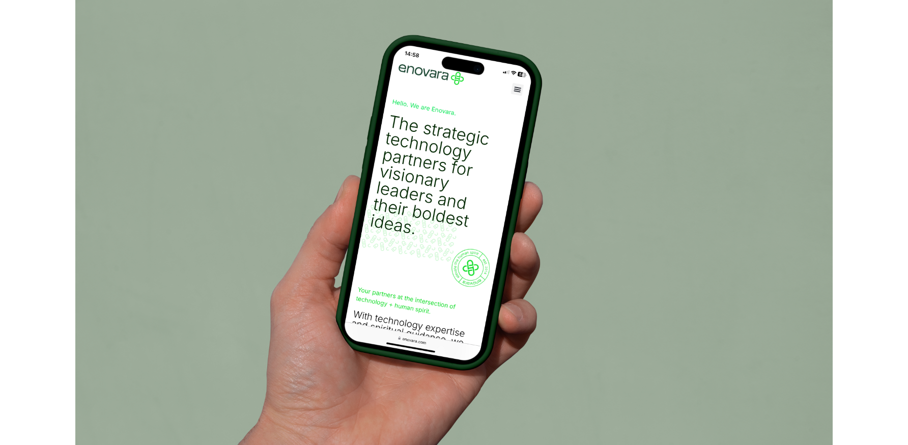 Person holding a green iPhone displaying Enovara's website with green text on a white background, against a plain light green wall.
