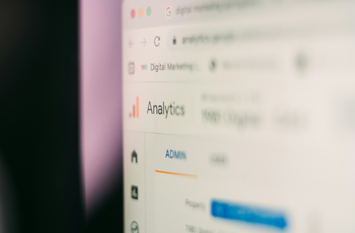 Computer screen displaying an analytics dashboard with blurred text and graphs.