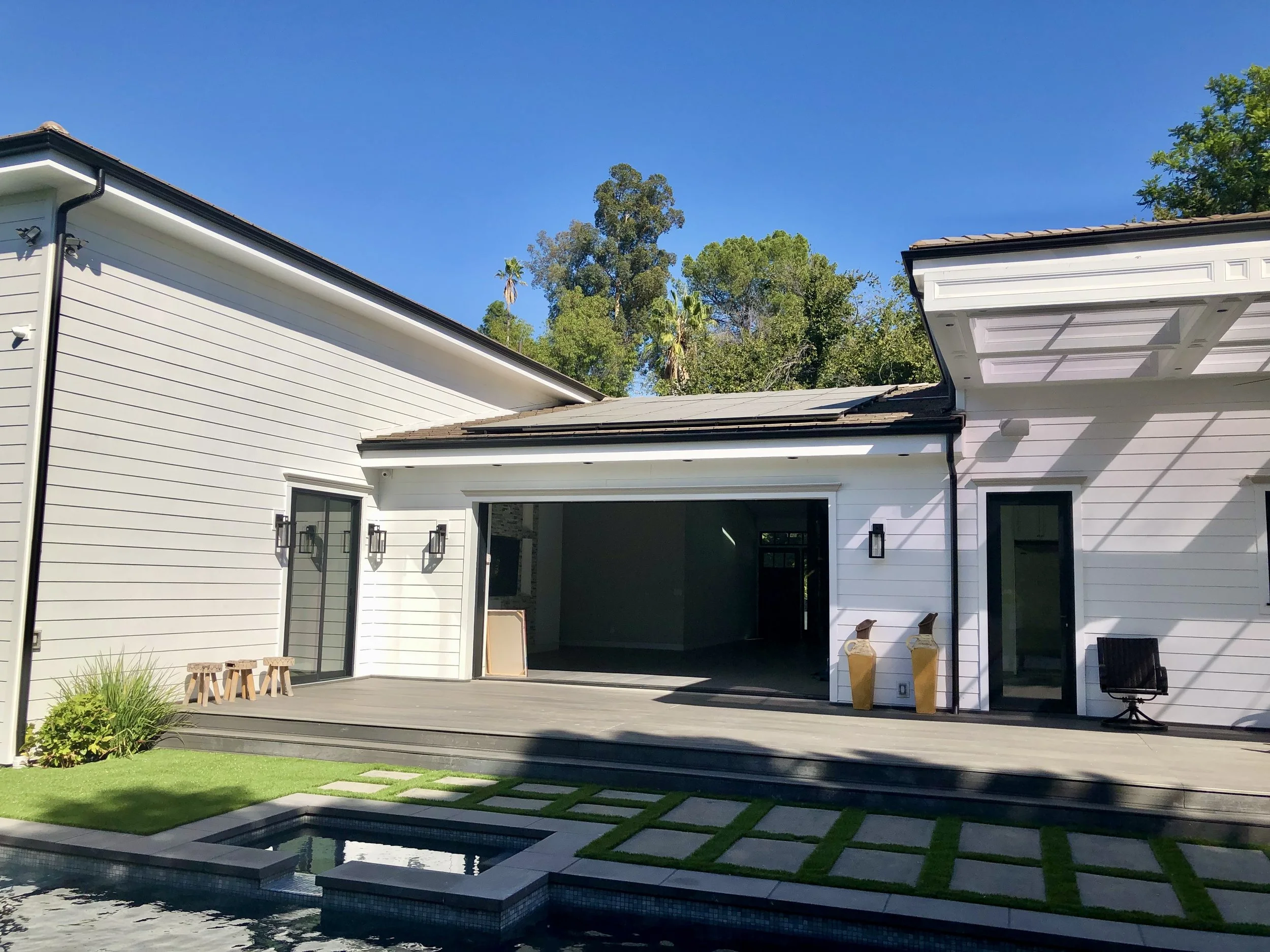 Luxury backyard renovation including pool, concrete hardscape, turf, and deck upgrade