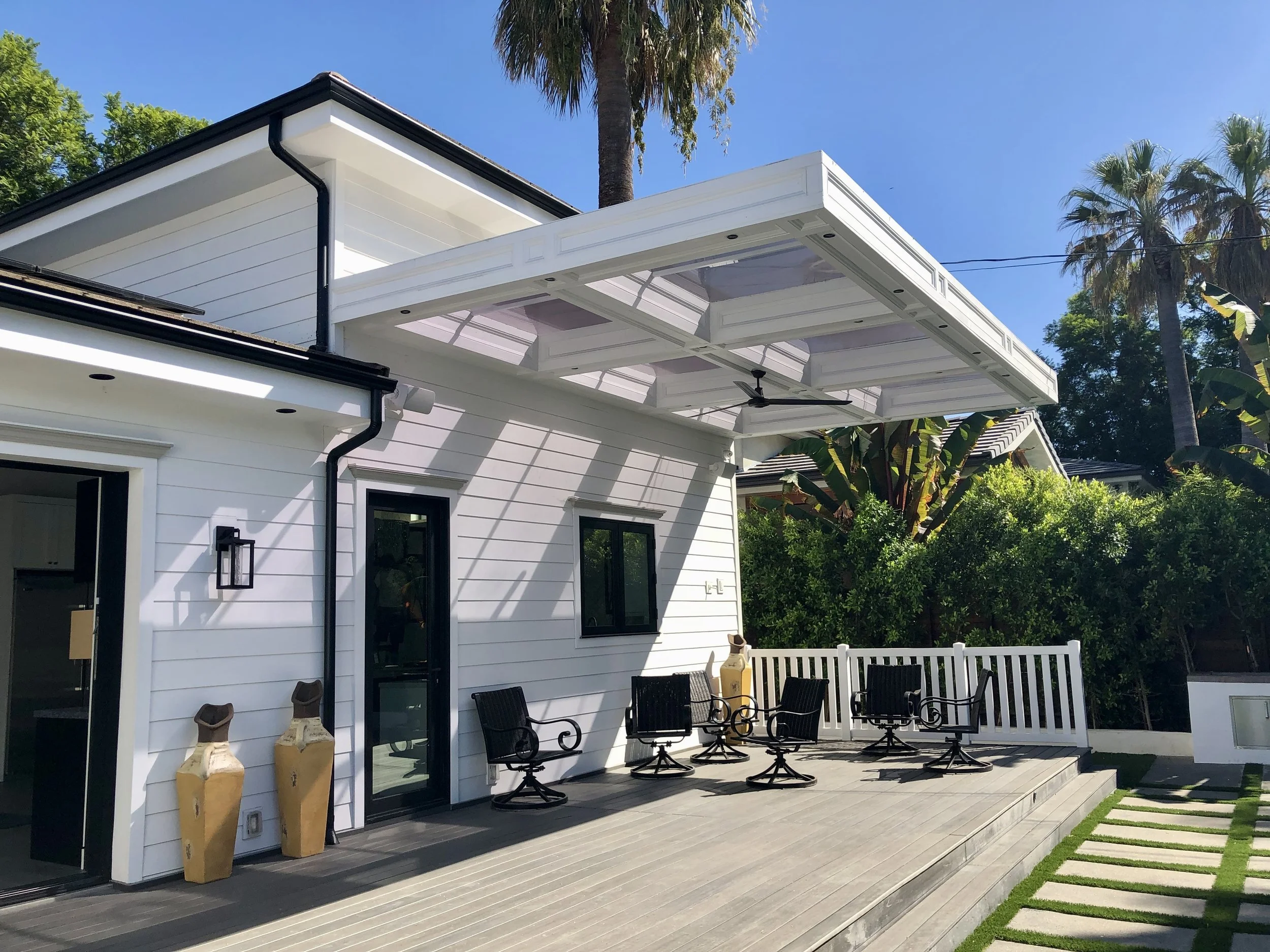Modern backyard design featuring pool, turf, and custom concrete deck in Los Angeles.