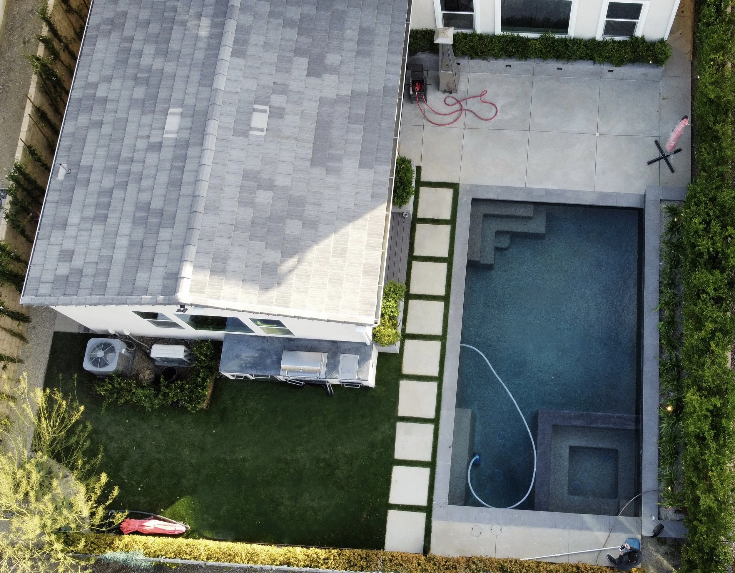 Backyard design with pool, turf, and outdoor entertainment area