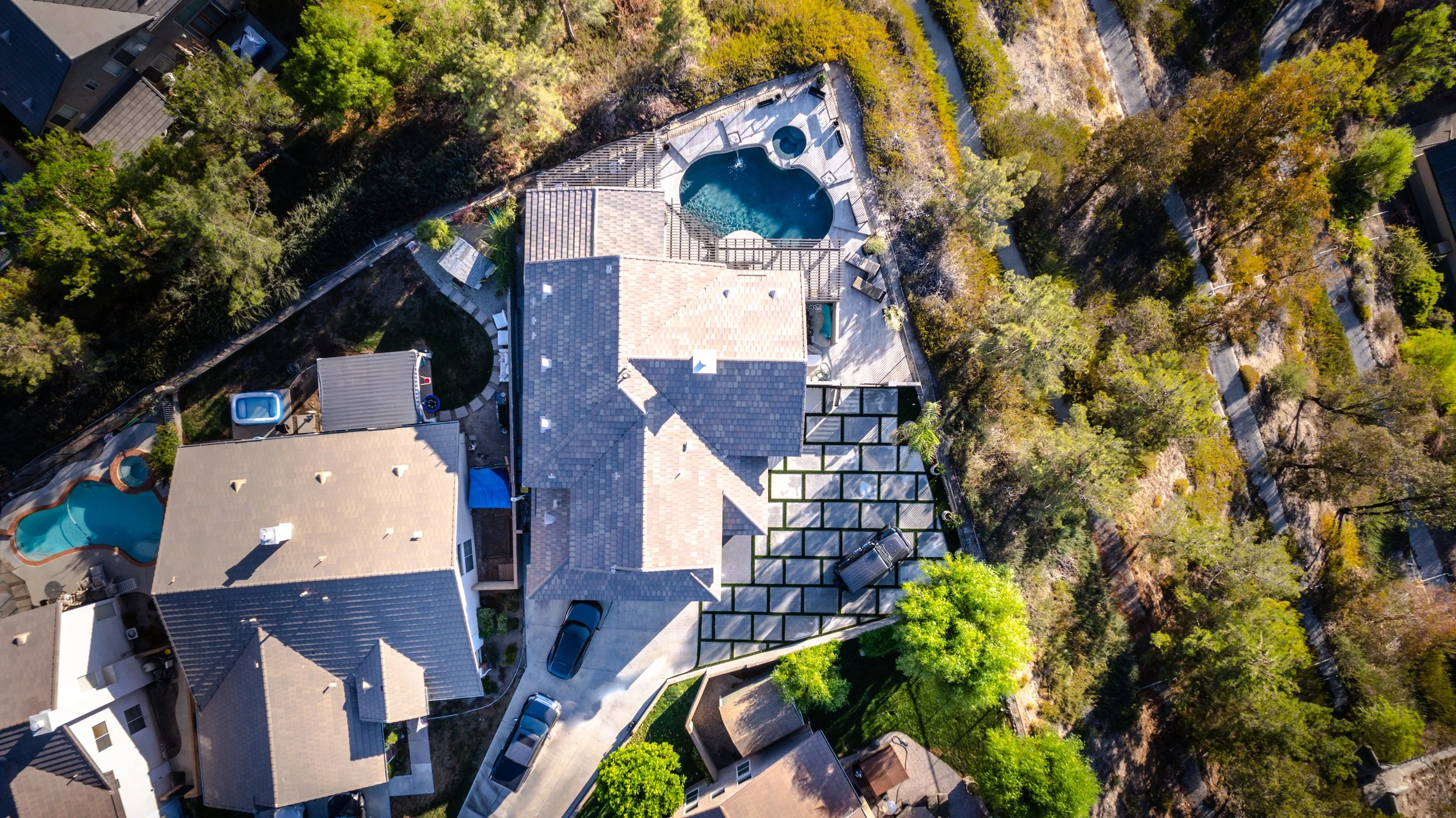 Custom pool installation with surrounding hardscape and design