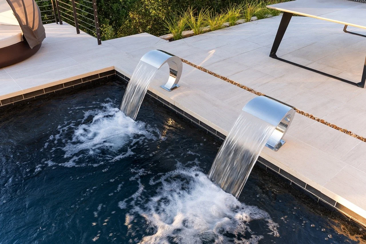 Luxury pool deck remodel with modern fire pit by Lonestar Builders Los Angeles”