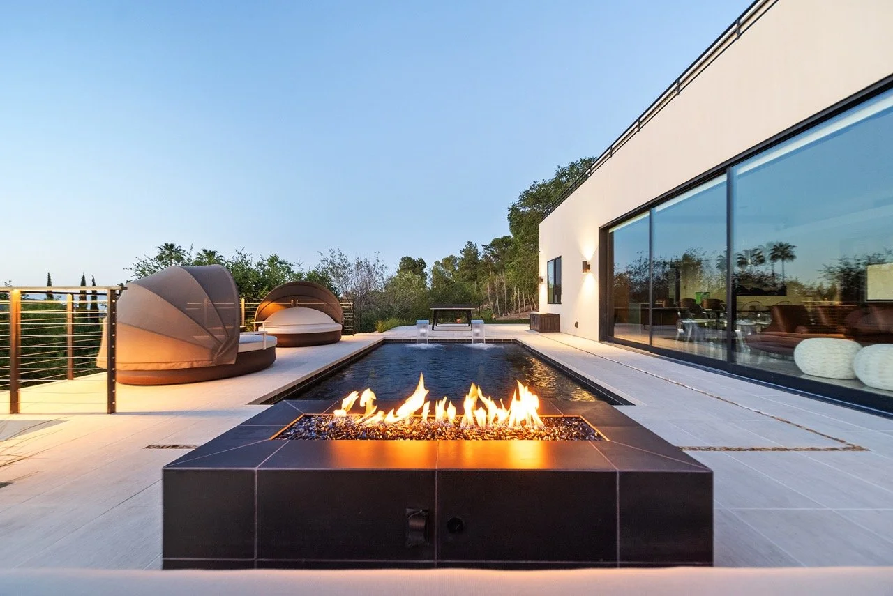 Modern pool deck remodel with custom fire pit by Lonestar Builders Los Angeles