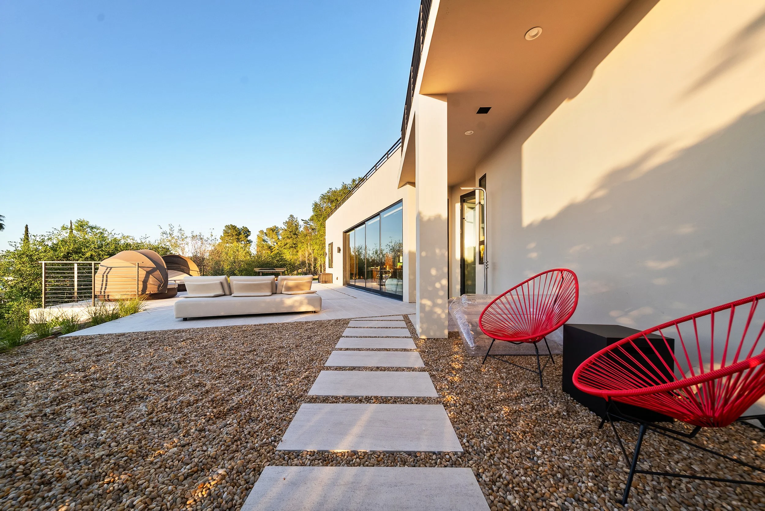 High-end backyard pool renovation Los Angeles with fire pit and outdoor lounge