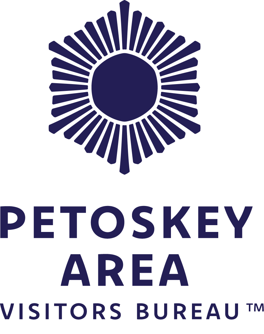 Logo for Petoskey Area.com with a map outline of Michigan, highlighting the Petoskey area with a star marker, and the text "PETOSKEY AREA.COM" in large letters with "PETOSKEY AREA" in beige and ".COM" in green.