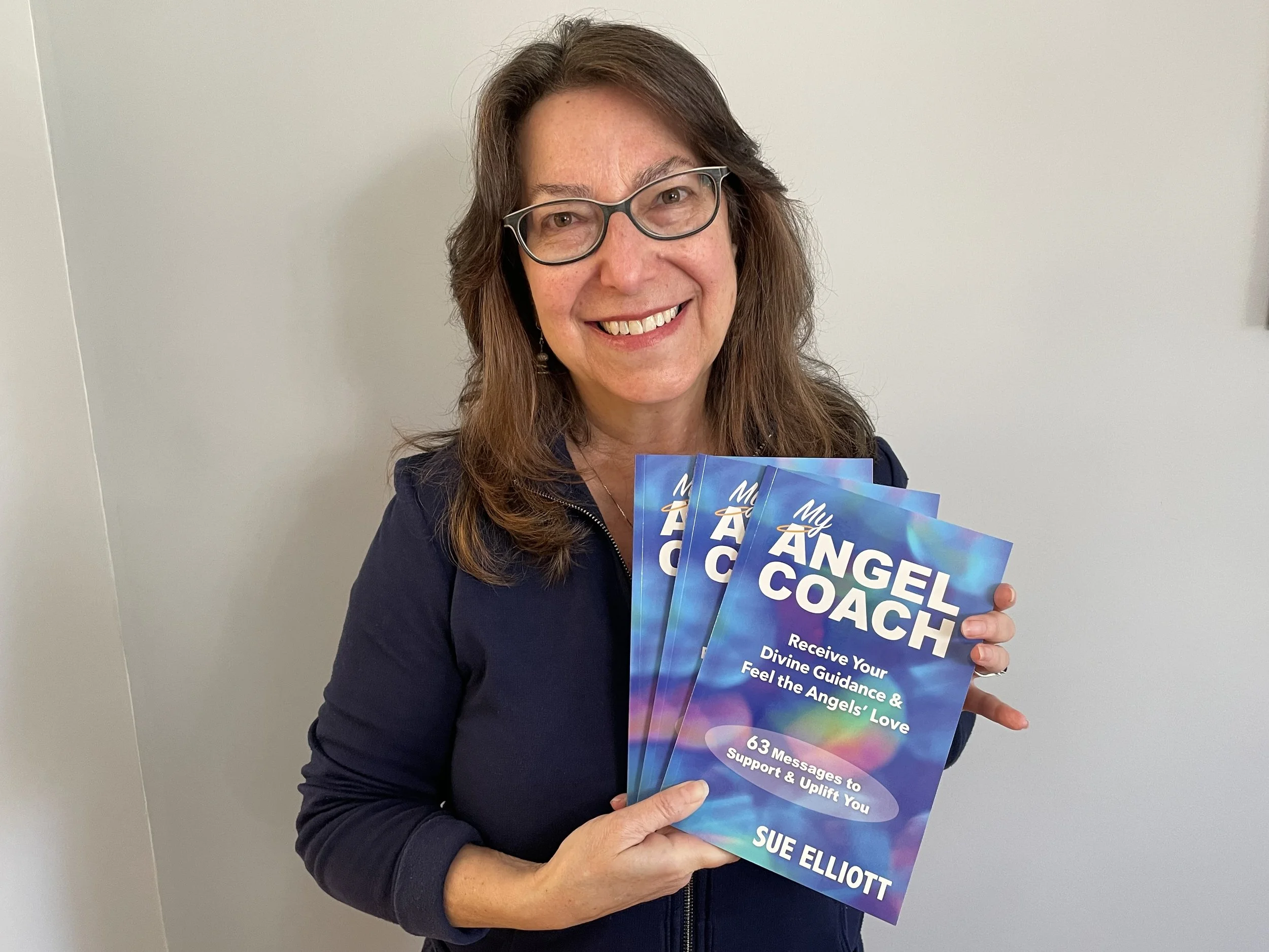 Sue with copies of her new book, My Angel Coach