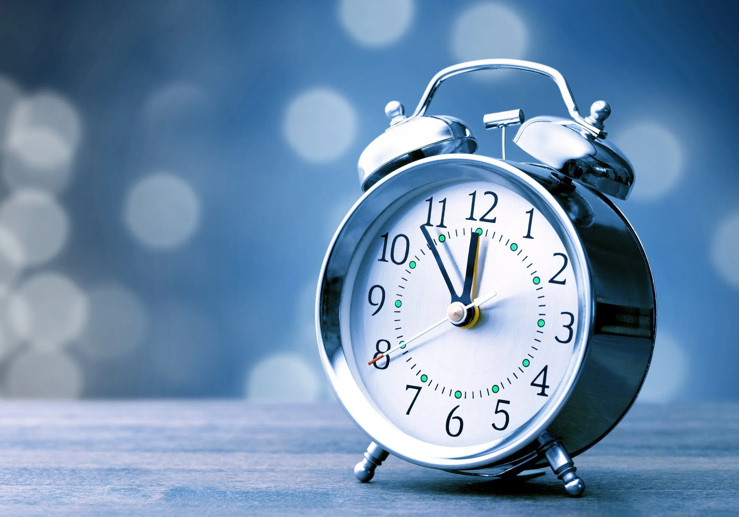 Silver alarm clock with magical blue background