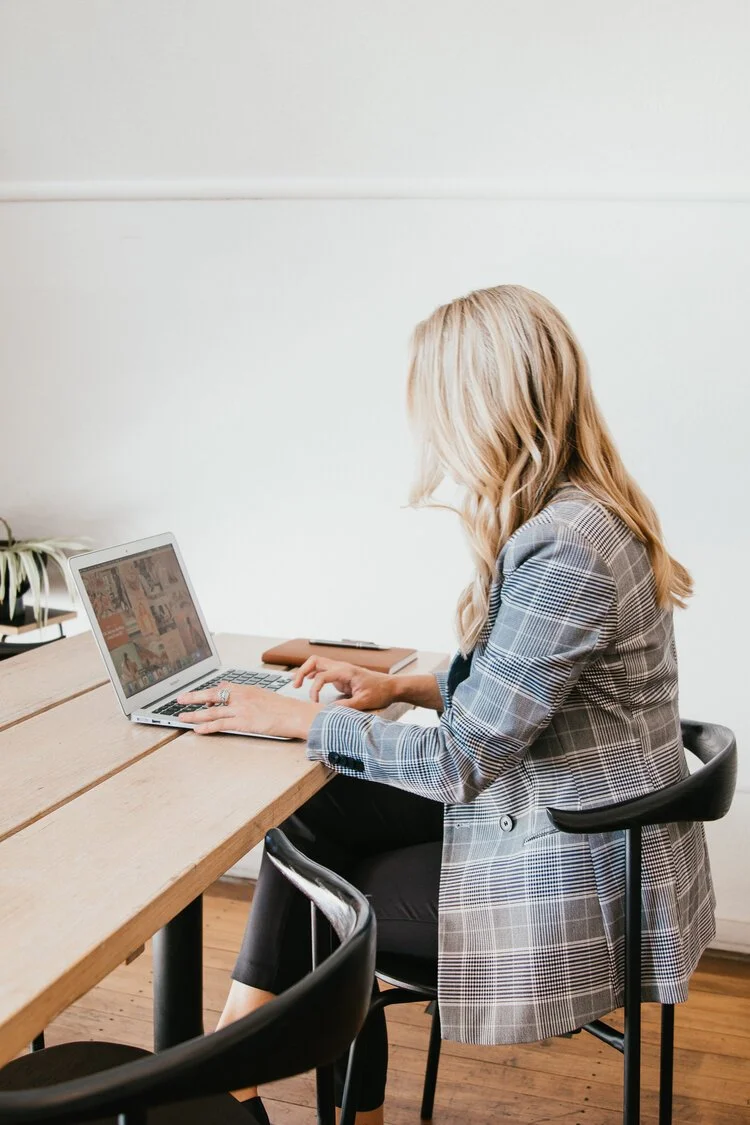 Texas eXp Realty transaction coordinator working on real estate contracts at a desk