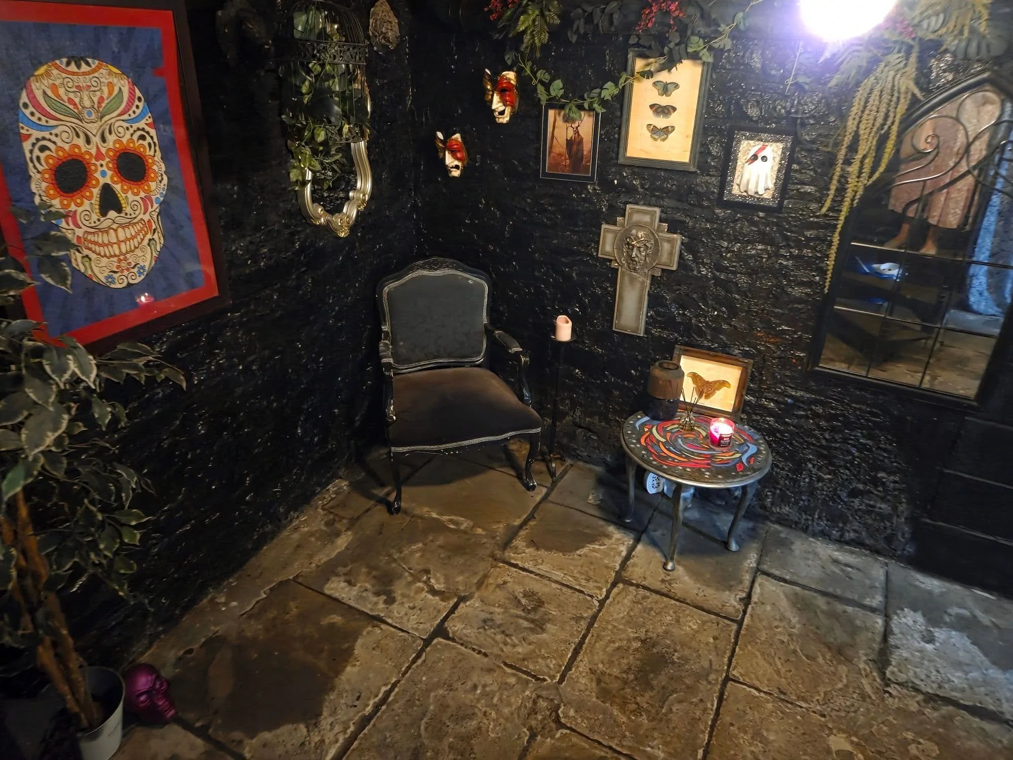 A seating area painted black with Gothic decorations