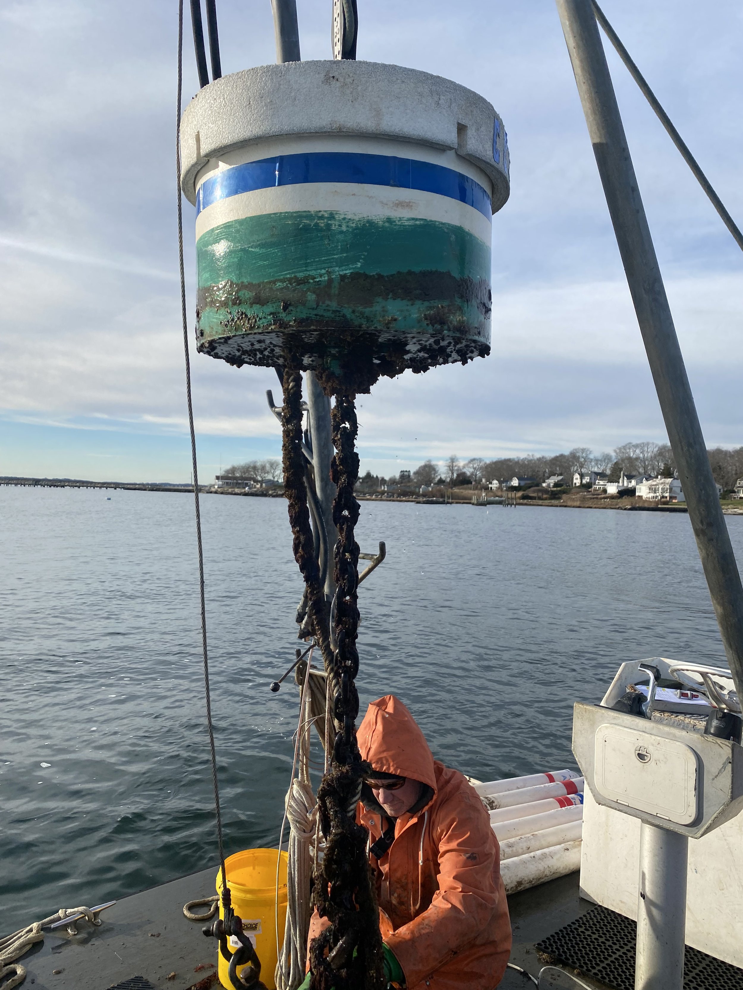 A photo of a mooring being placed in the Mystic River