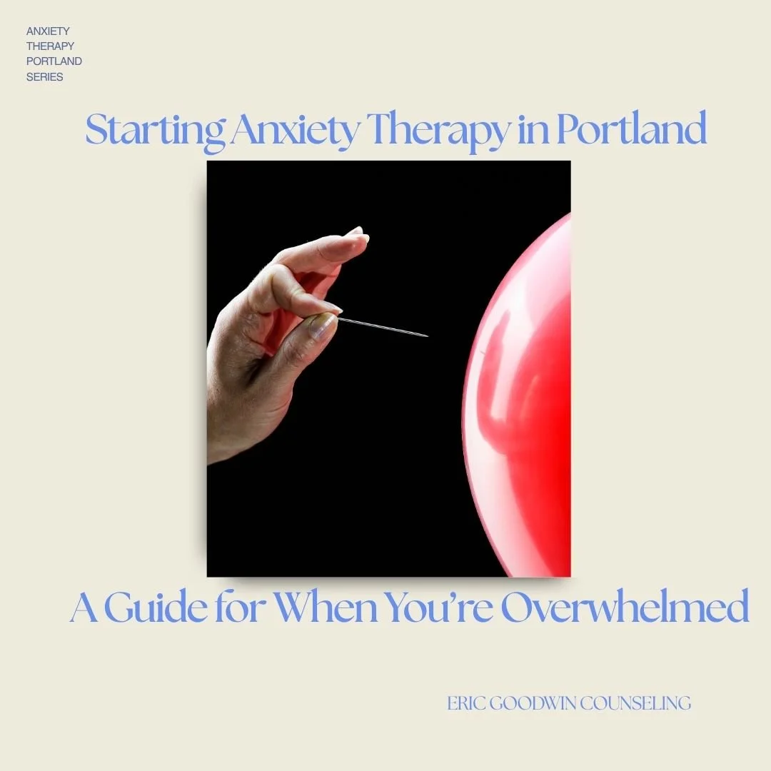 Hand holding a pin near a red balloon—capturing the tension and overwhelm that often comes before seeking anxiety therapy in Portland.