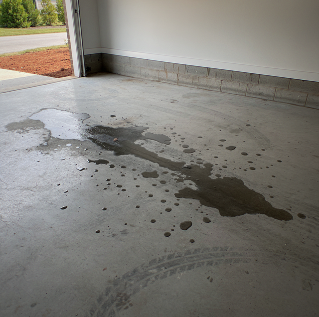 Peeled epoxy sheet lifted from smooth grey concrete slab