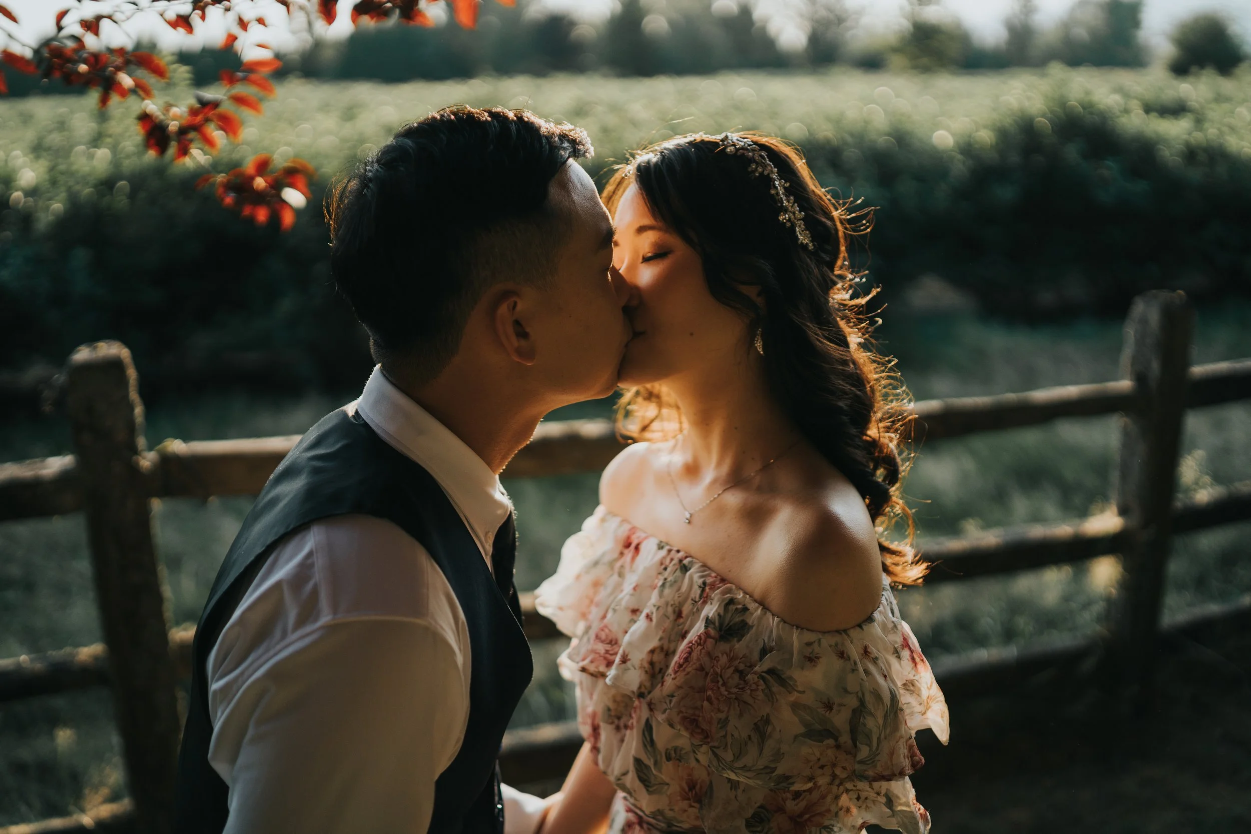 Bride and Groom Kissing romantically by the sunlit orchards