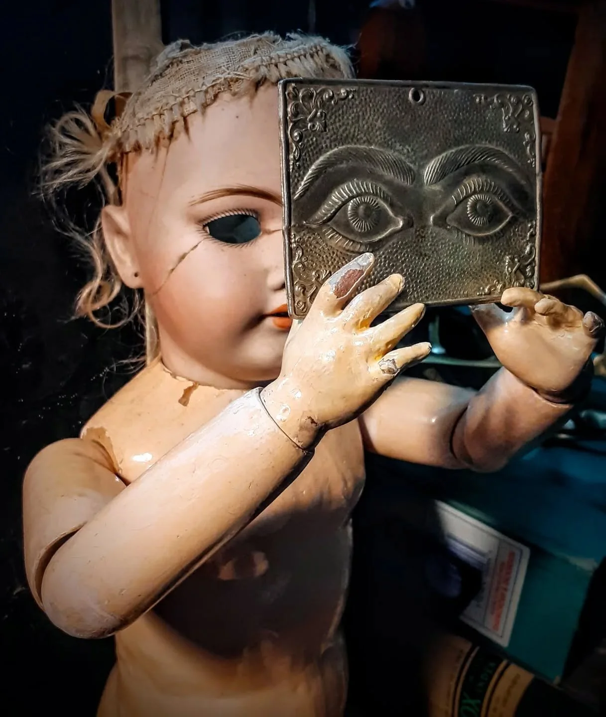 Dolls do invite play...
This is (I think) the largest bisque (porcelain) doll I have. She was chosen for the excellent cracking across her face, as well as because she has pierced ears. Often the dolls lurk about in their found form for a while befor