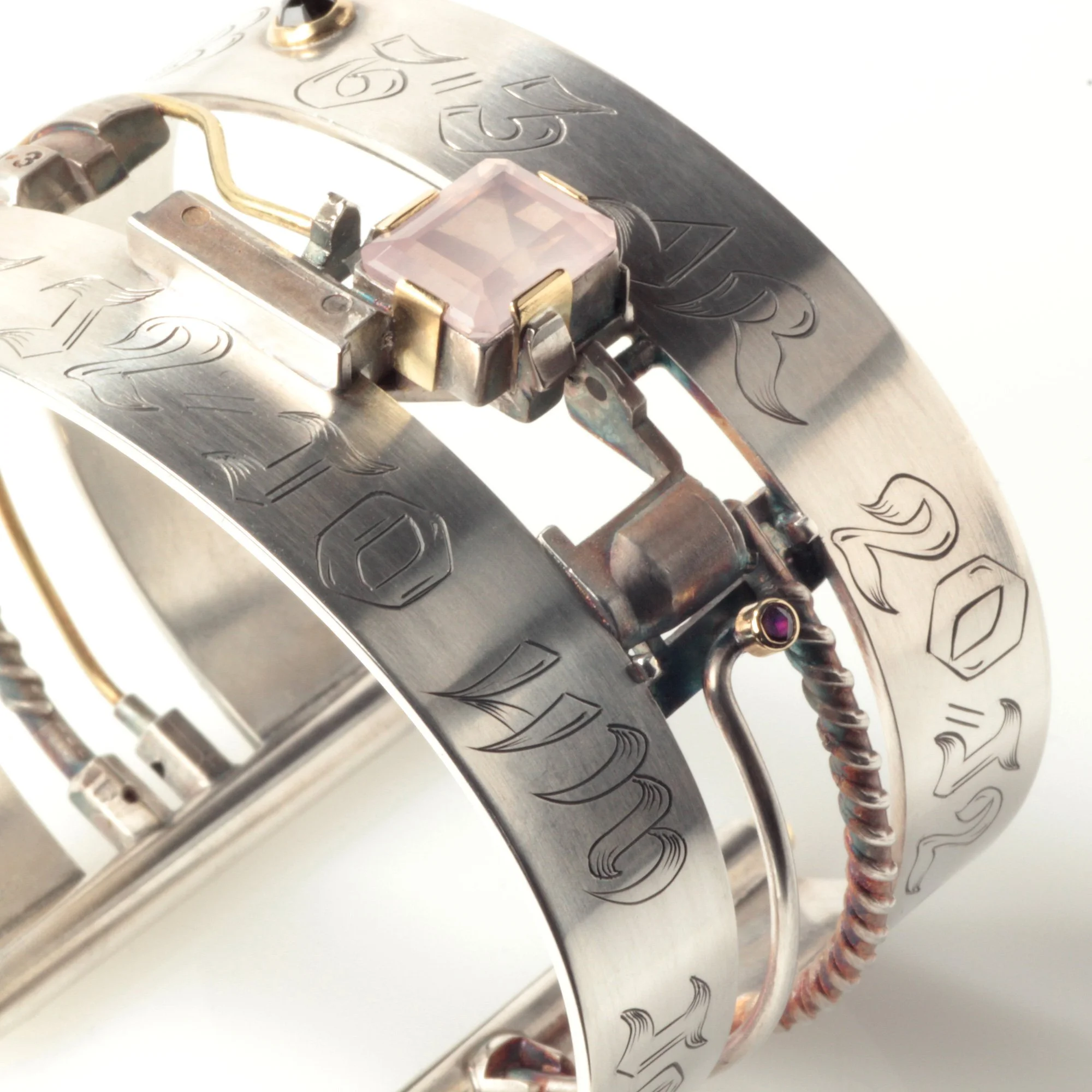 A large silver cuff set with rose quartz