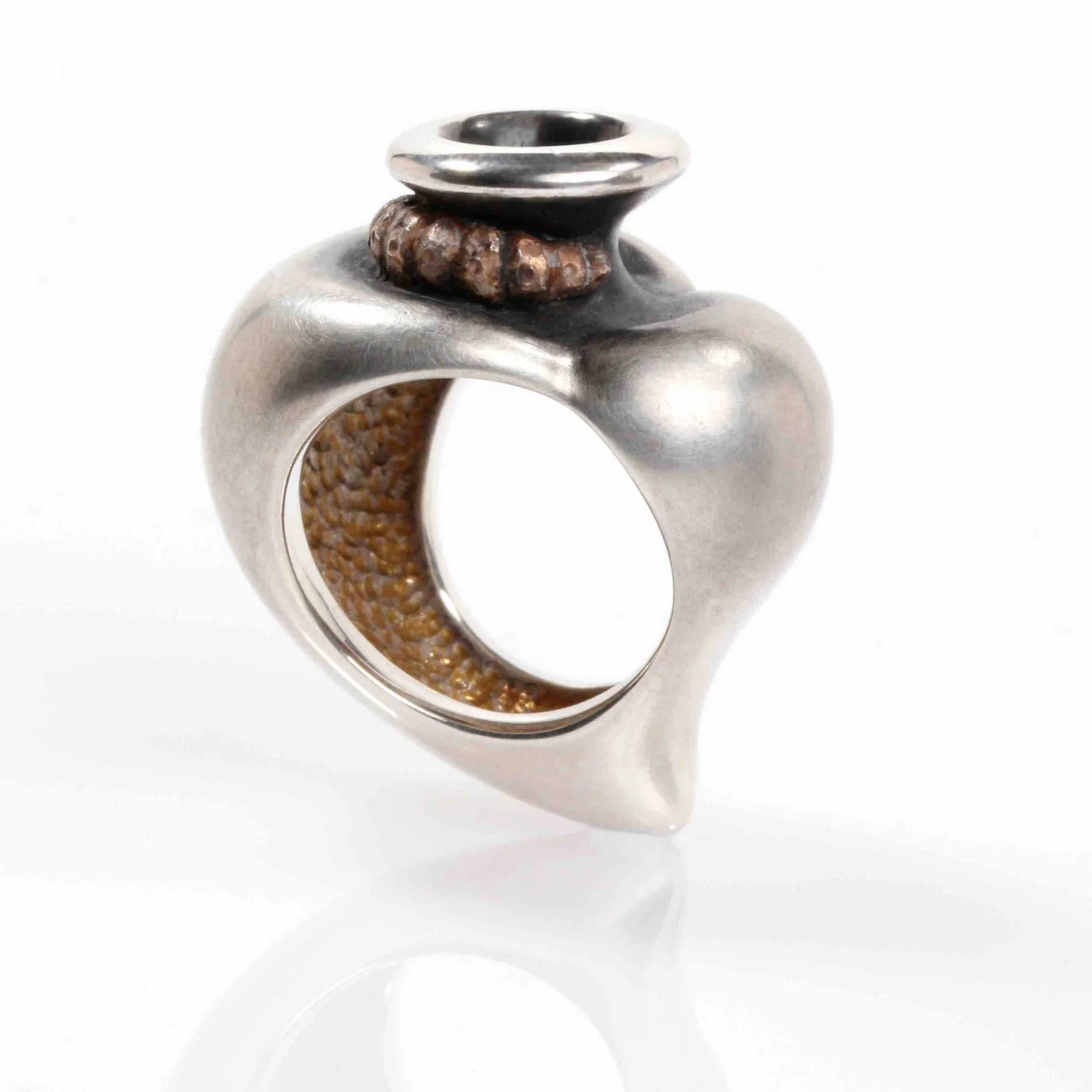 A ring in the form of a heart with a funnel, with a larval form curled around the base of the funnel