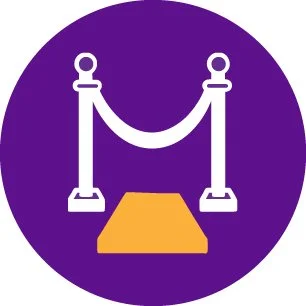 Icon of a red carpet with stanchions and velvet ropes on a purple circular background.
