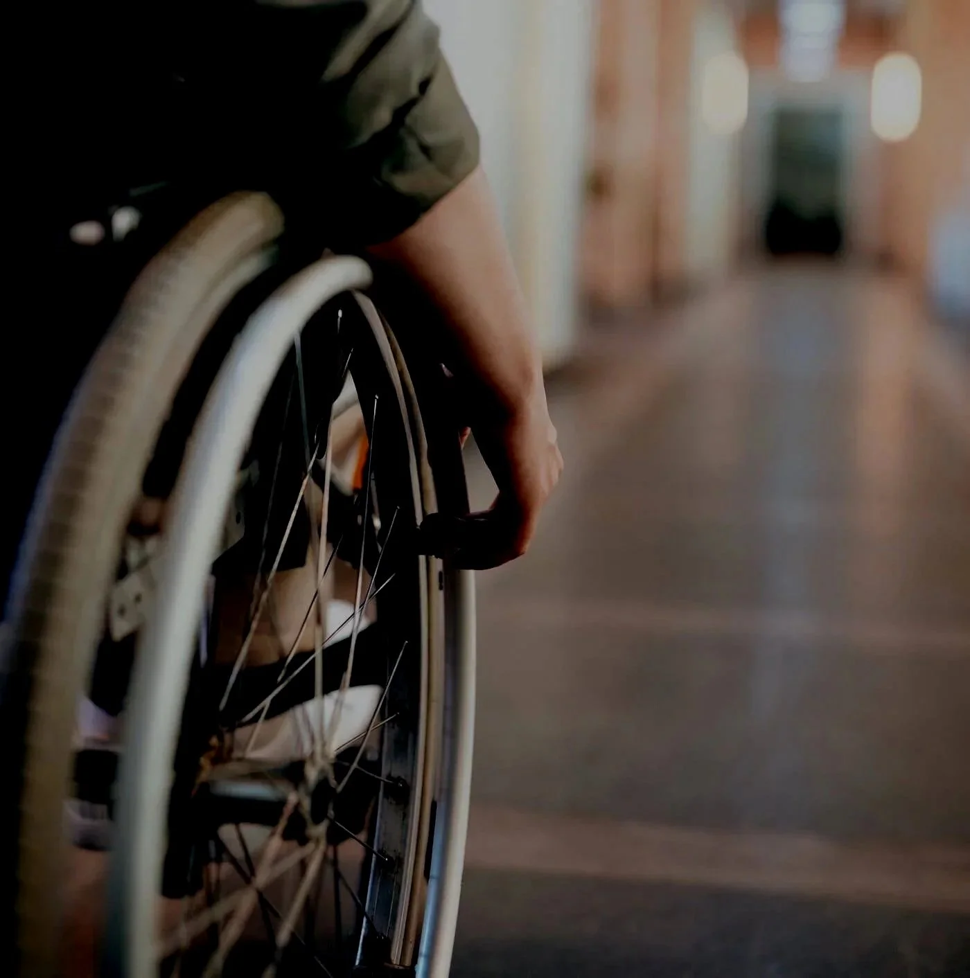 hand rolling a wheel on a wheel chair