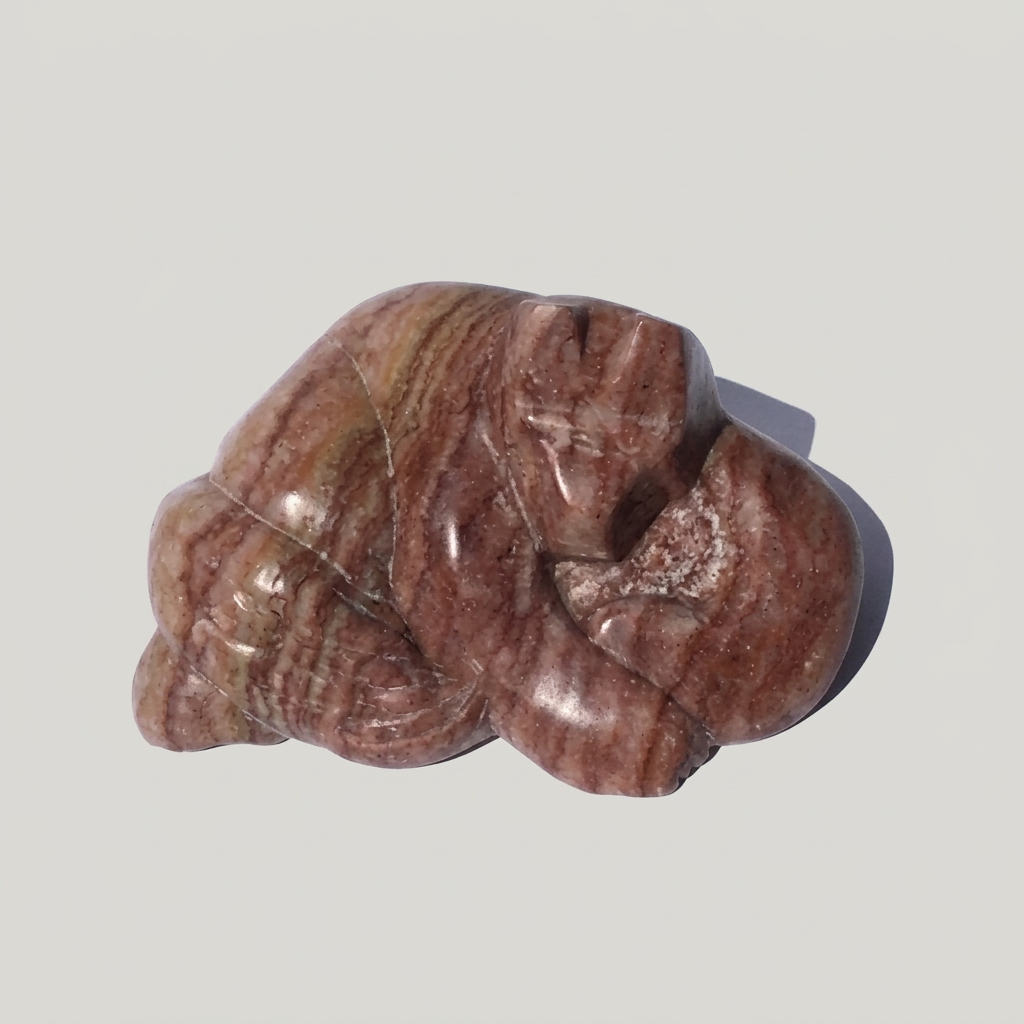 Hand carved alabaster figure of a cat napping