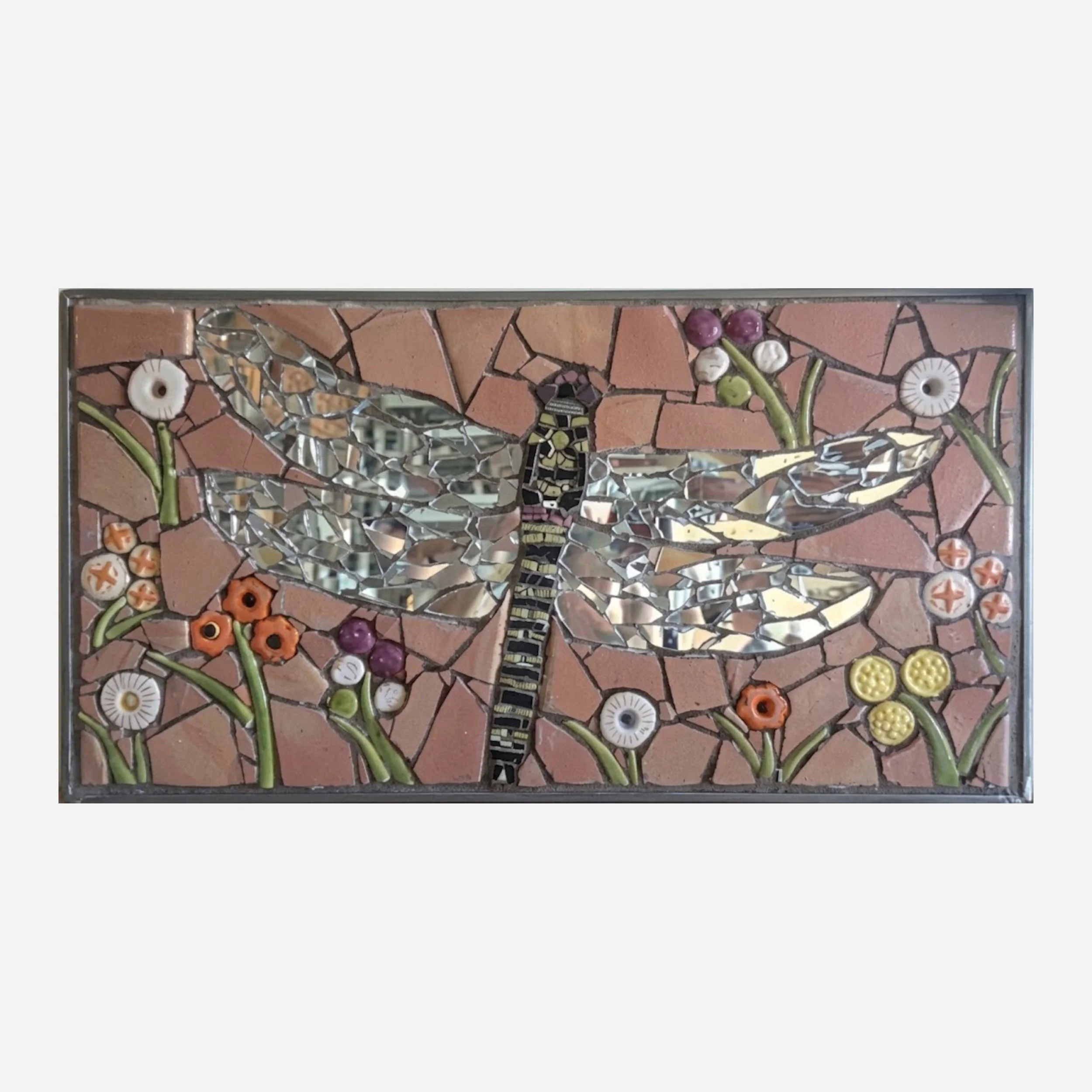 A metal framed rectangle mosaic of a dragonfly surrounded by flowers.