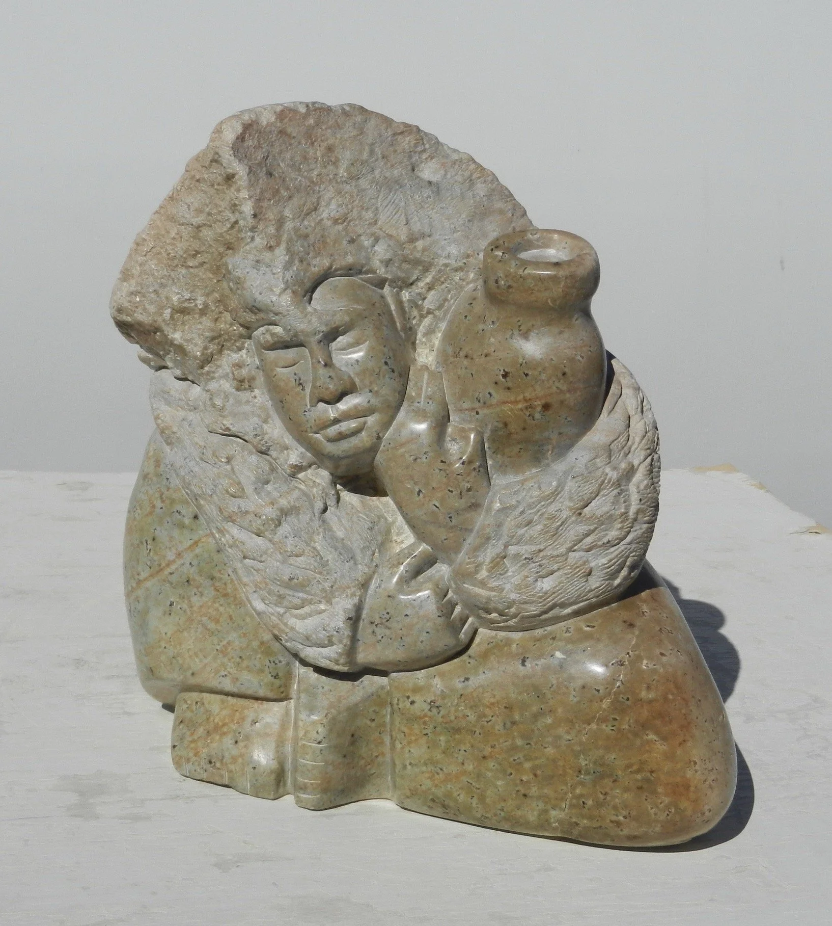 Brazilian talc carved in the image of a woman holding a water jug