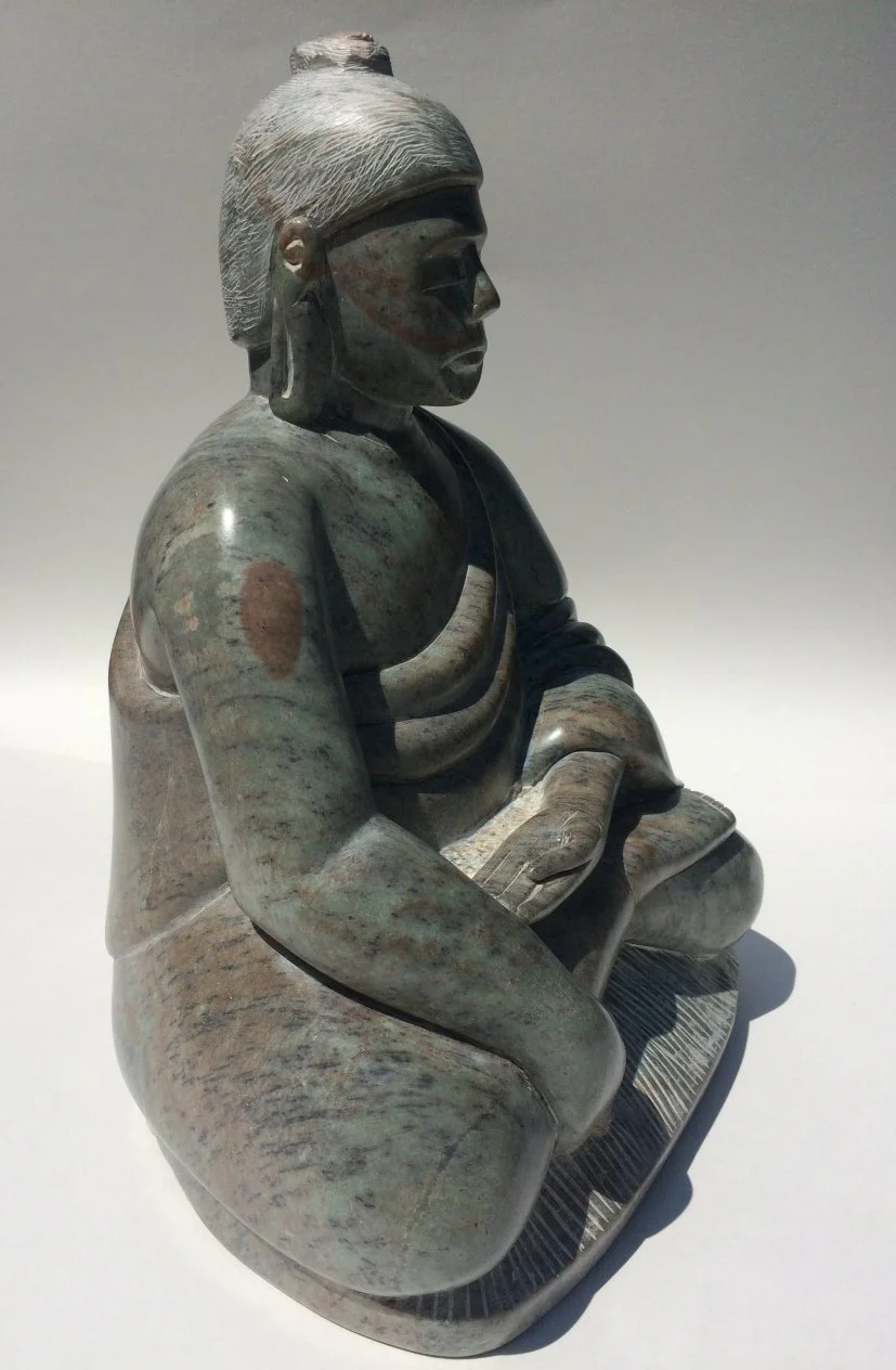 Carving of the Buddha in profile, sculpted from green Brazilian talc.