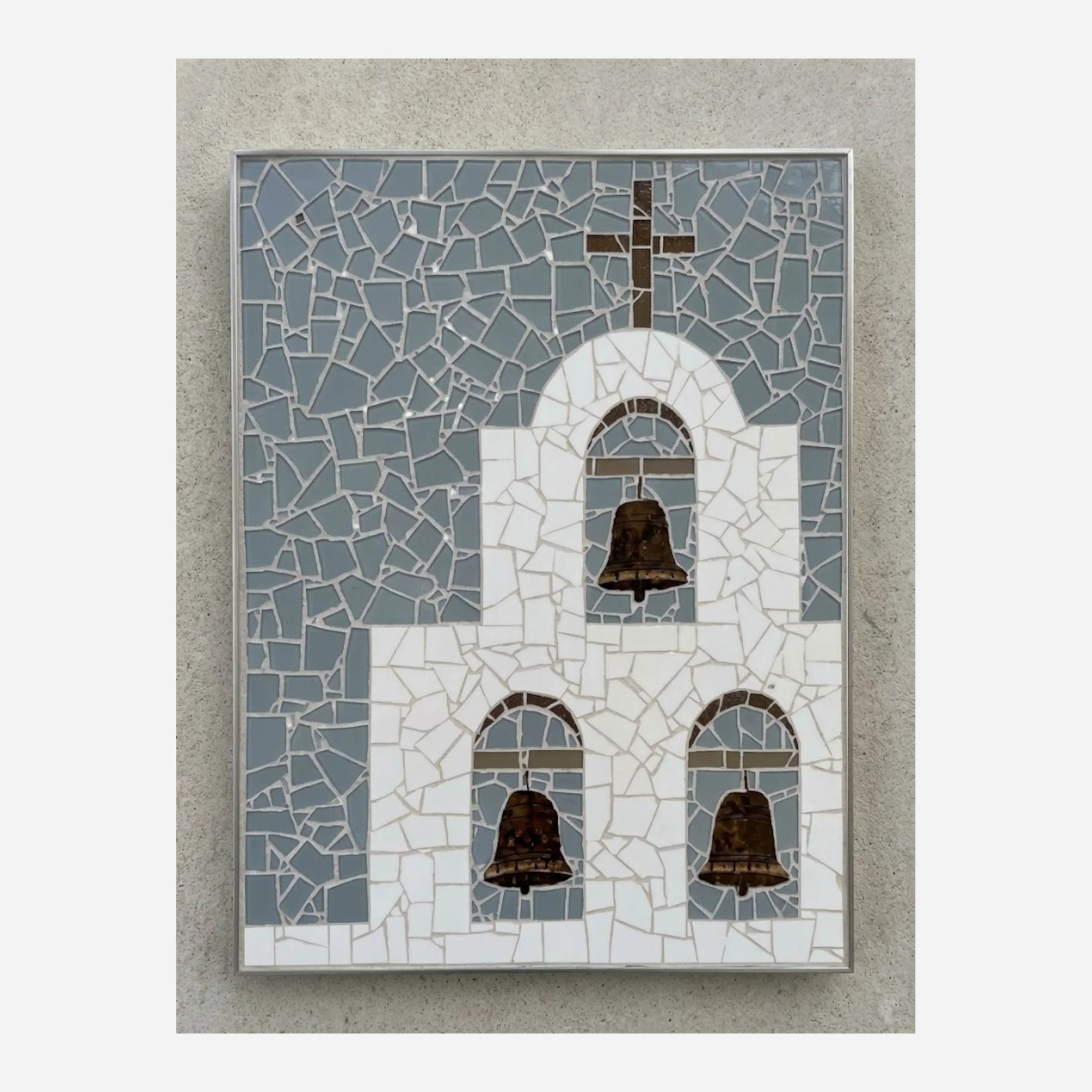 A mosaic of a church bell tower made from blue, white, and brown, glass.