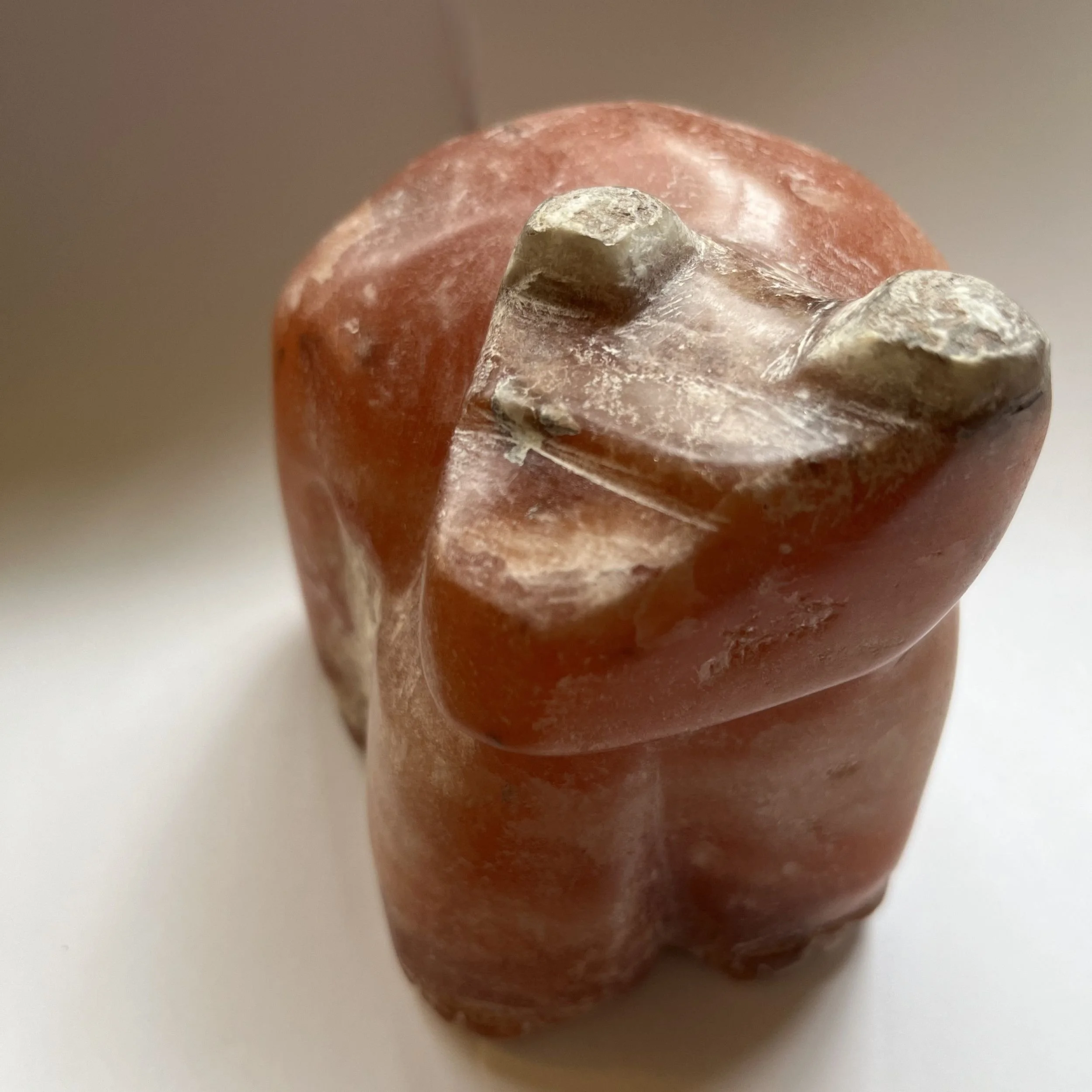 Hand carved alabaster brown bear, shuffling along