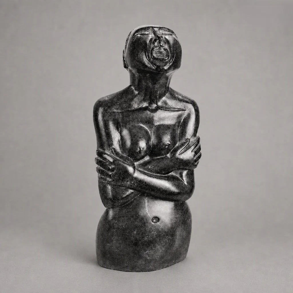 The front view of a large, black, carved soapstone figure of a woman wailing