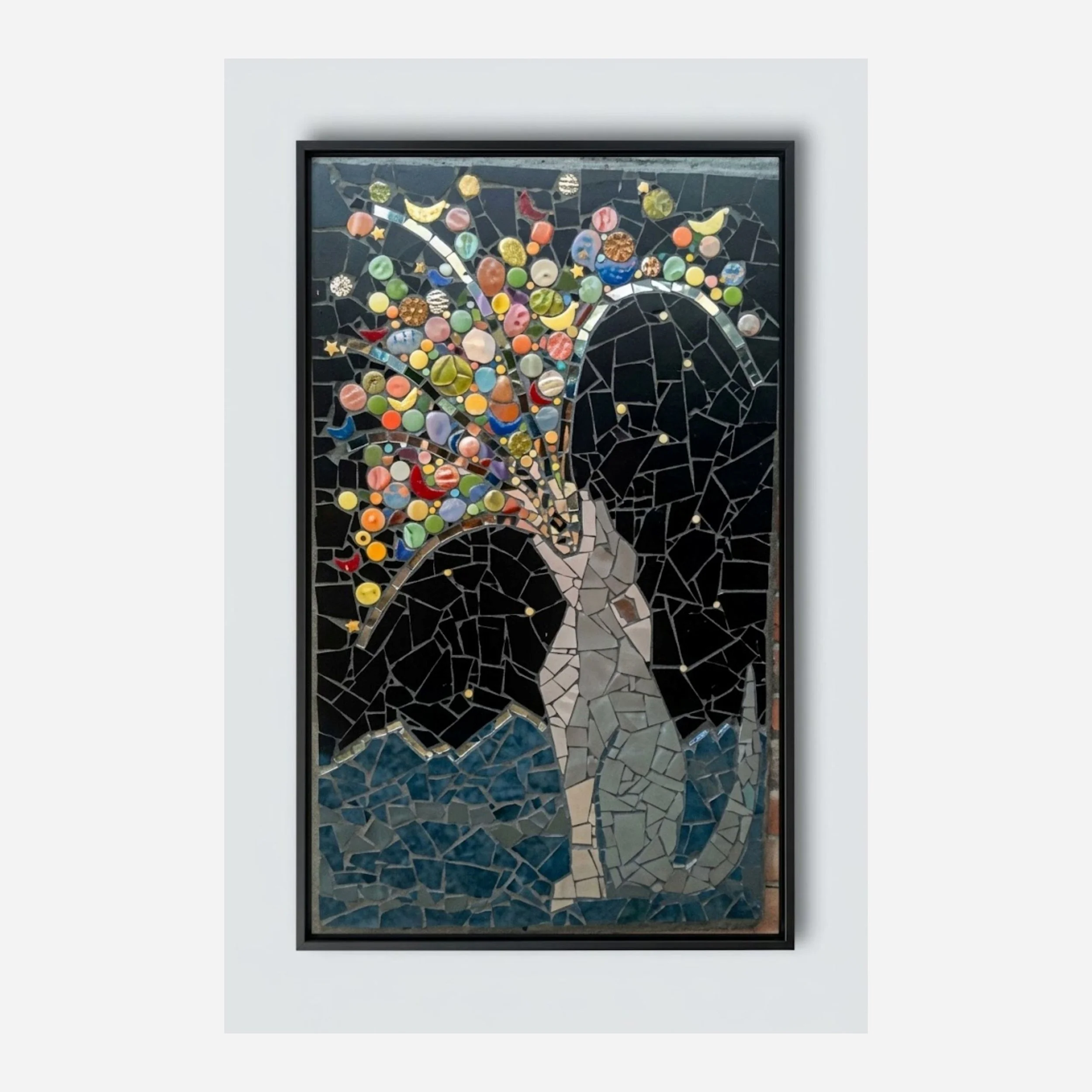 A portrait mosaic of a coyote howling with mountains in the background.  The coyote's howl is represeted by colorful items like fruit, stars, rocks, and other items that exist in the universe.