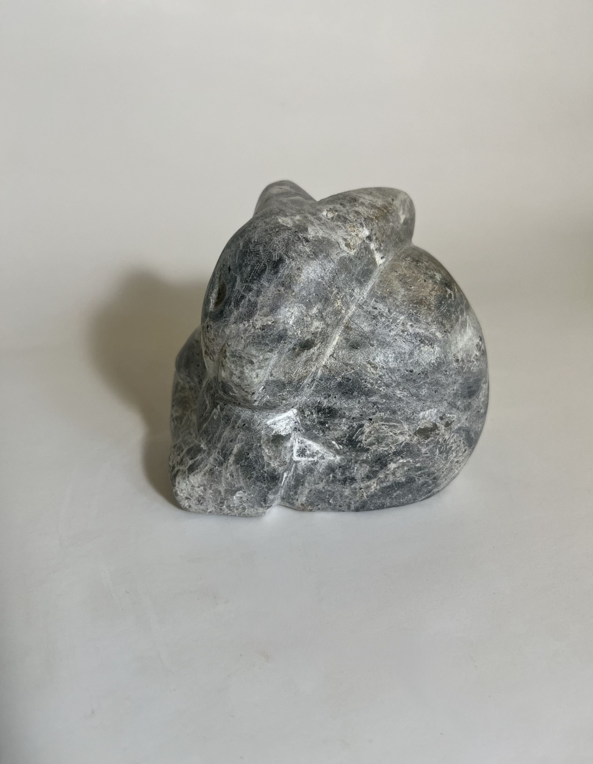 A rabbit kit carved from blueish soapstone.