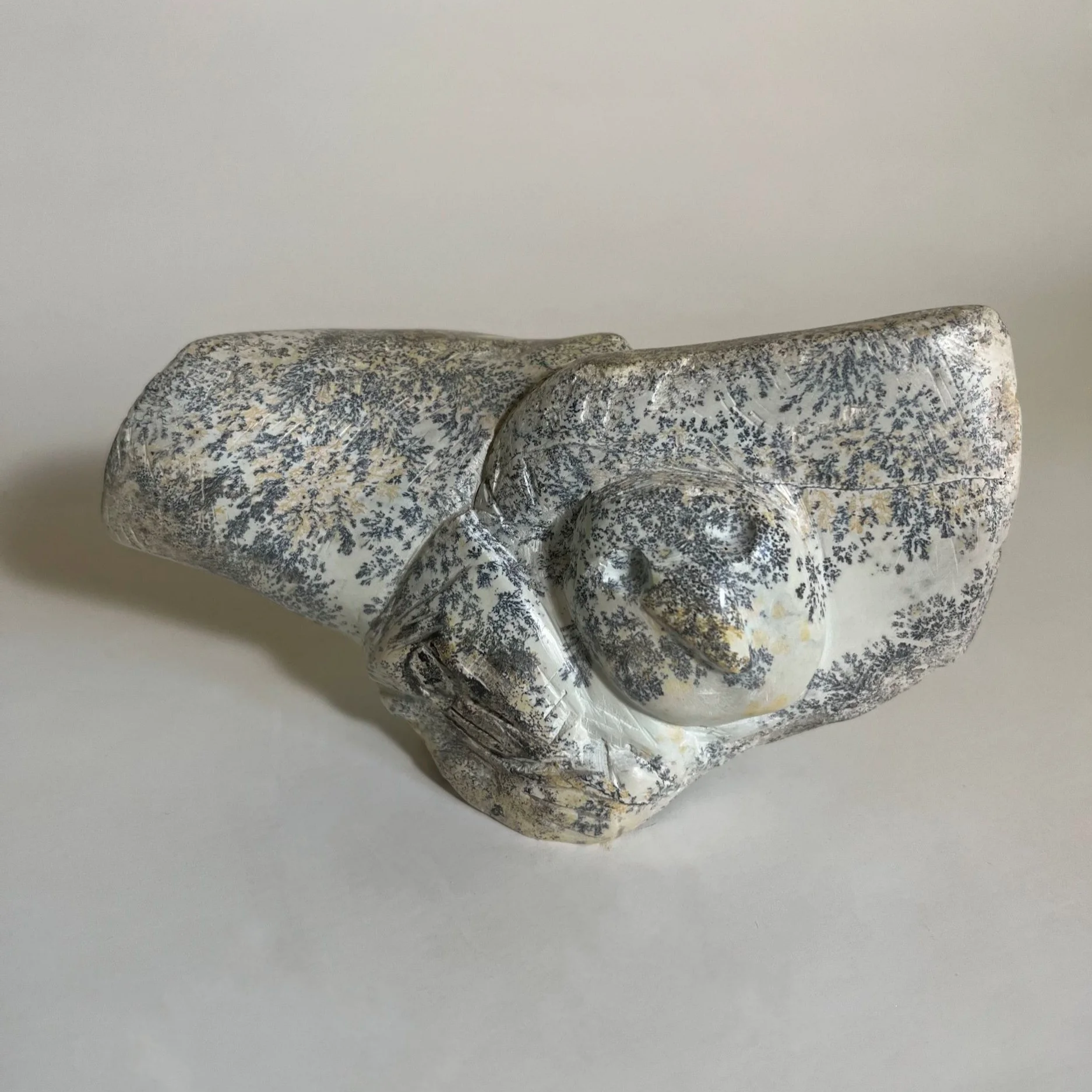 An abstract carving of an owl in flight, handcrafted from soapstone