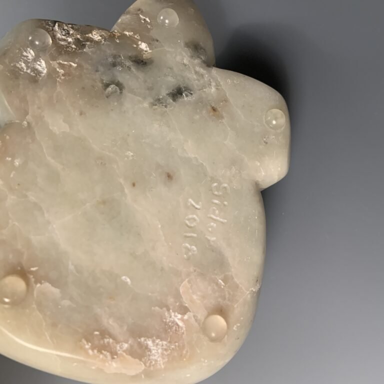 Artist mark and date on botton of green soapstone sculpture of a bear lying down