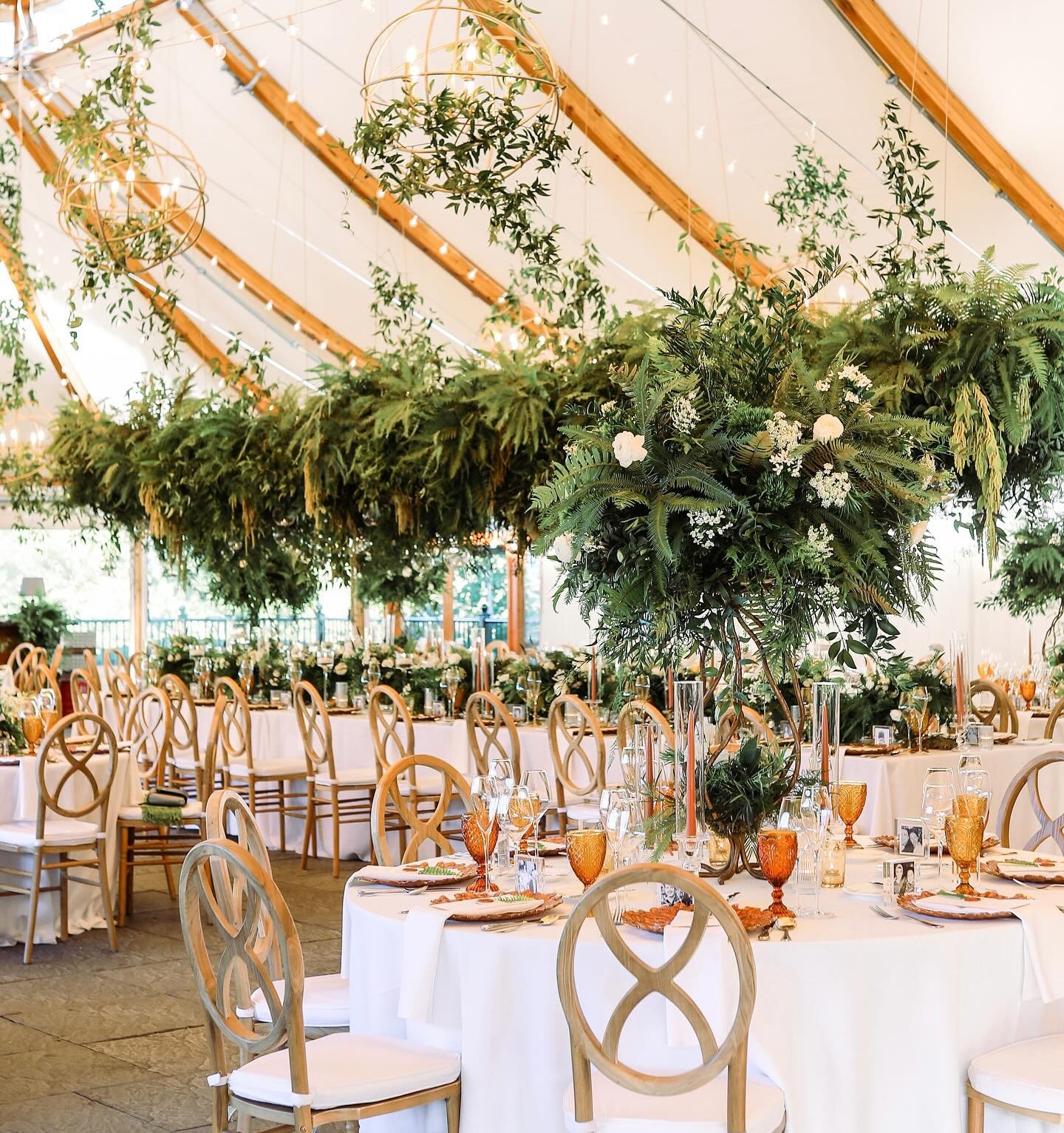 Castle Hill transformed into a garden oasis🌿Chandeliers dripped in delicate vines and ferns created an enchanting canopy over the head table while the soft glow of candlelight played off the foliage. Guests were surrounded by the ethereal beauty of 