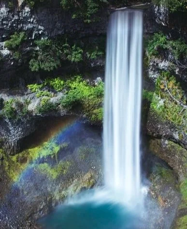 Waterfall into a basin with rainbow