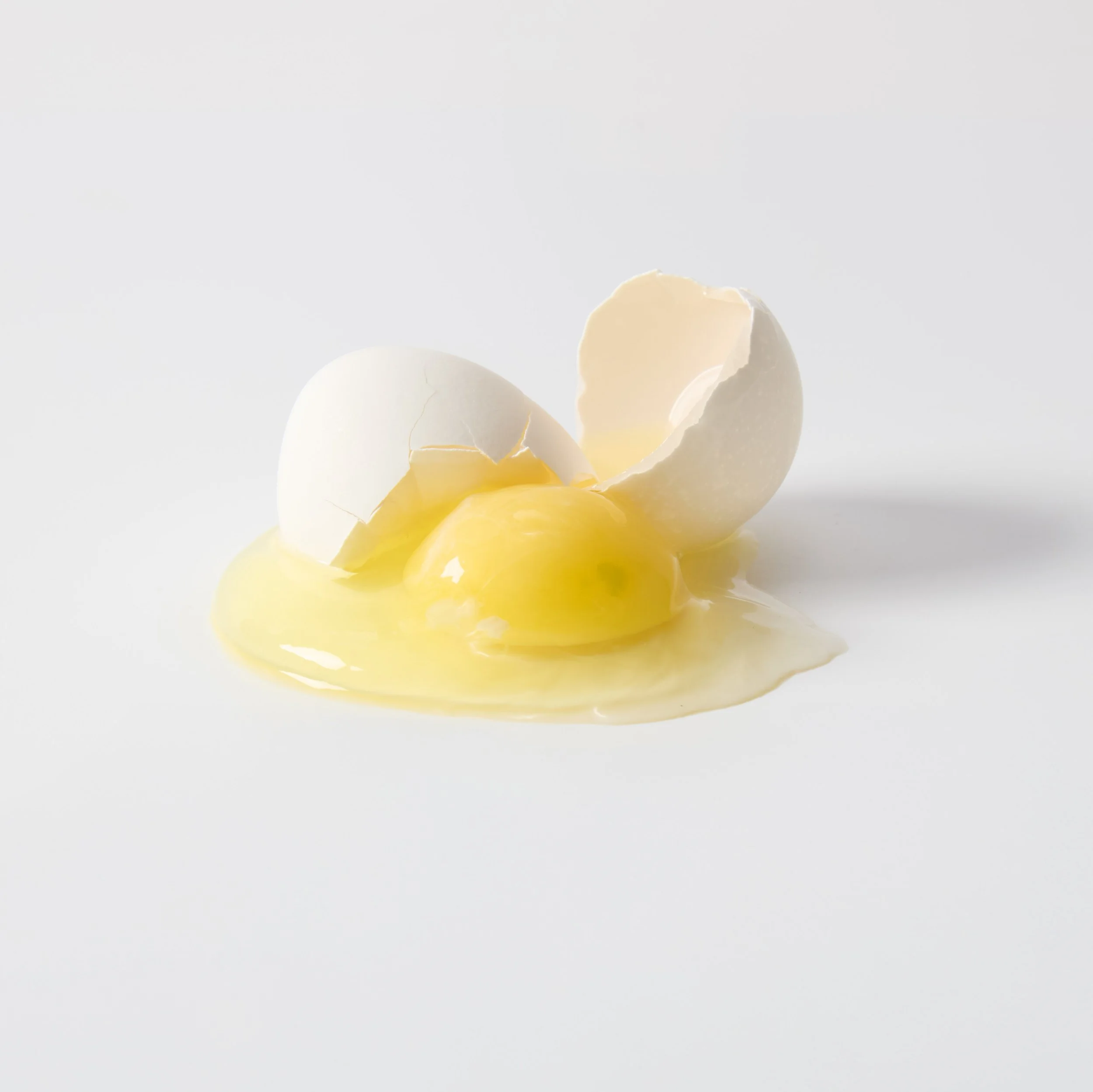 Cracked eggshells on a white background.