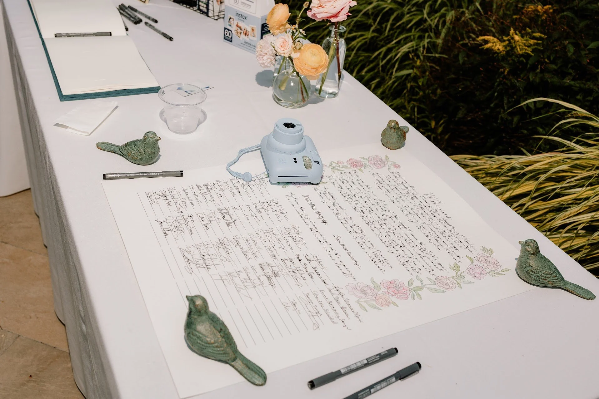 a quaker style marriage certificate with pens on a table waiting for signatures