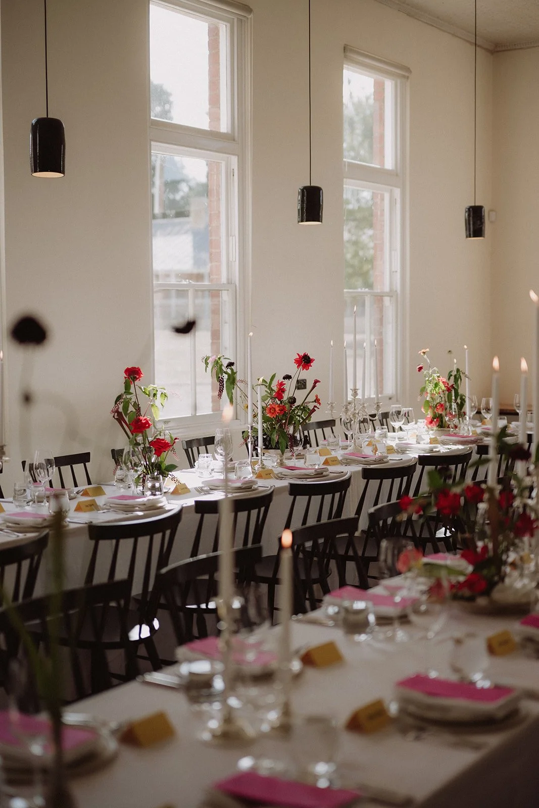 Wedding reception tables with contemporary floral centrepieces in Hobart, Agrarian Kitchen with Hall of Flame candles