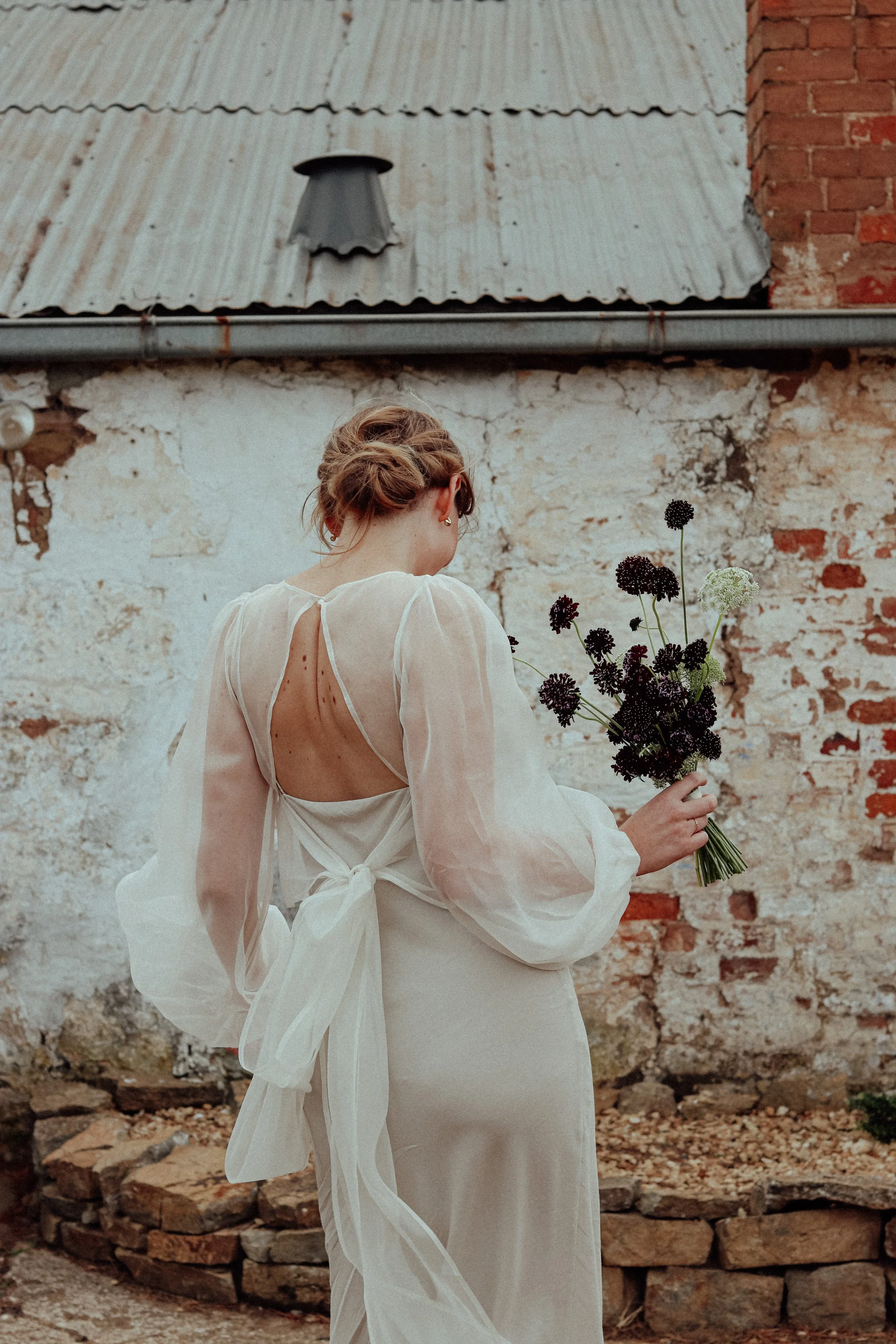Beautiful simple elegant bridal bouquet of burgundy scabiosa flowers, Tasmanian Winery wedding.