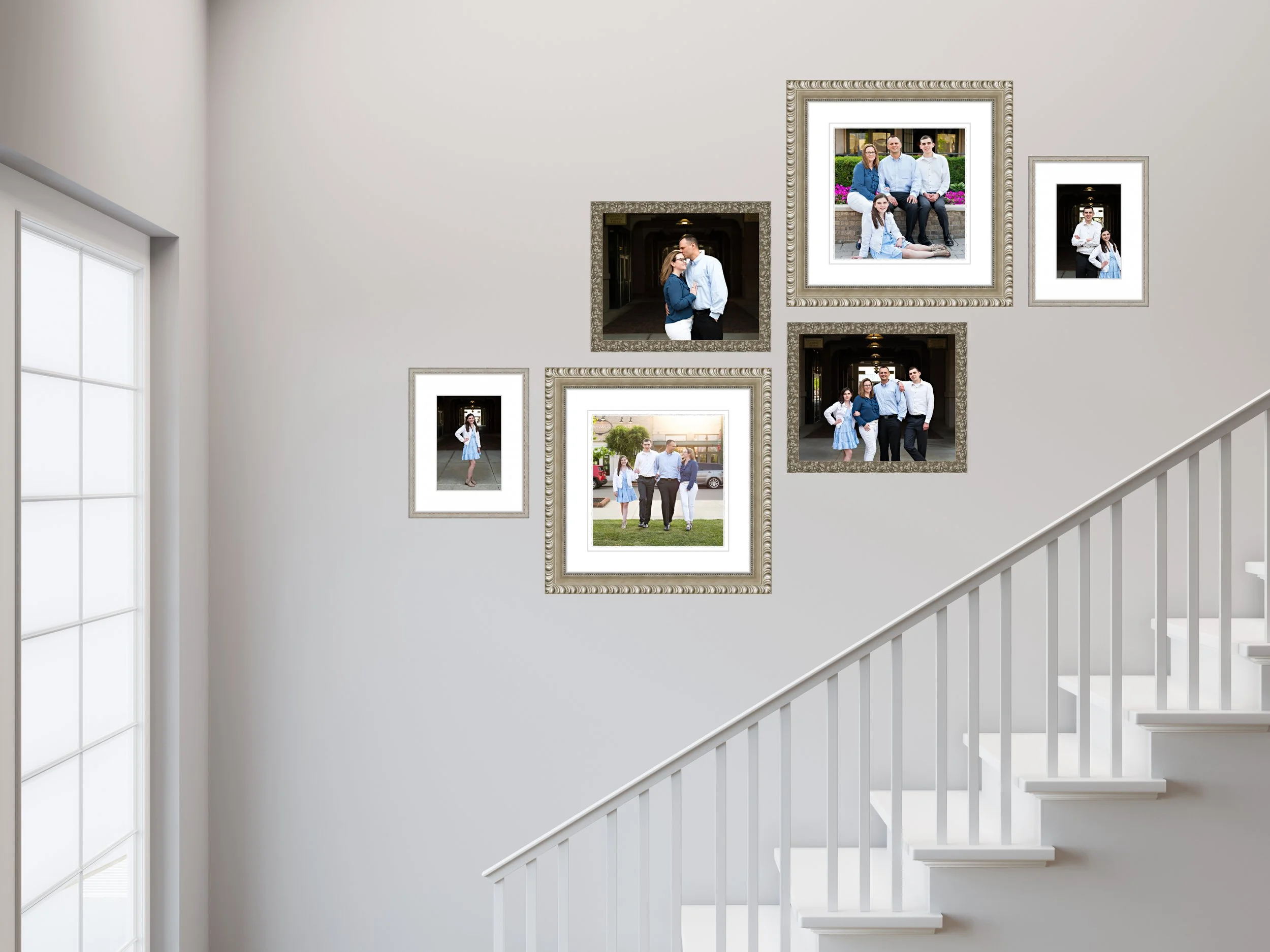 A gallery of framed family portraits beautifully arranged on the wall by the stairs.