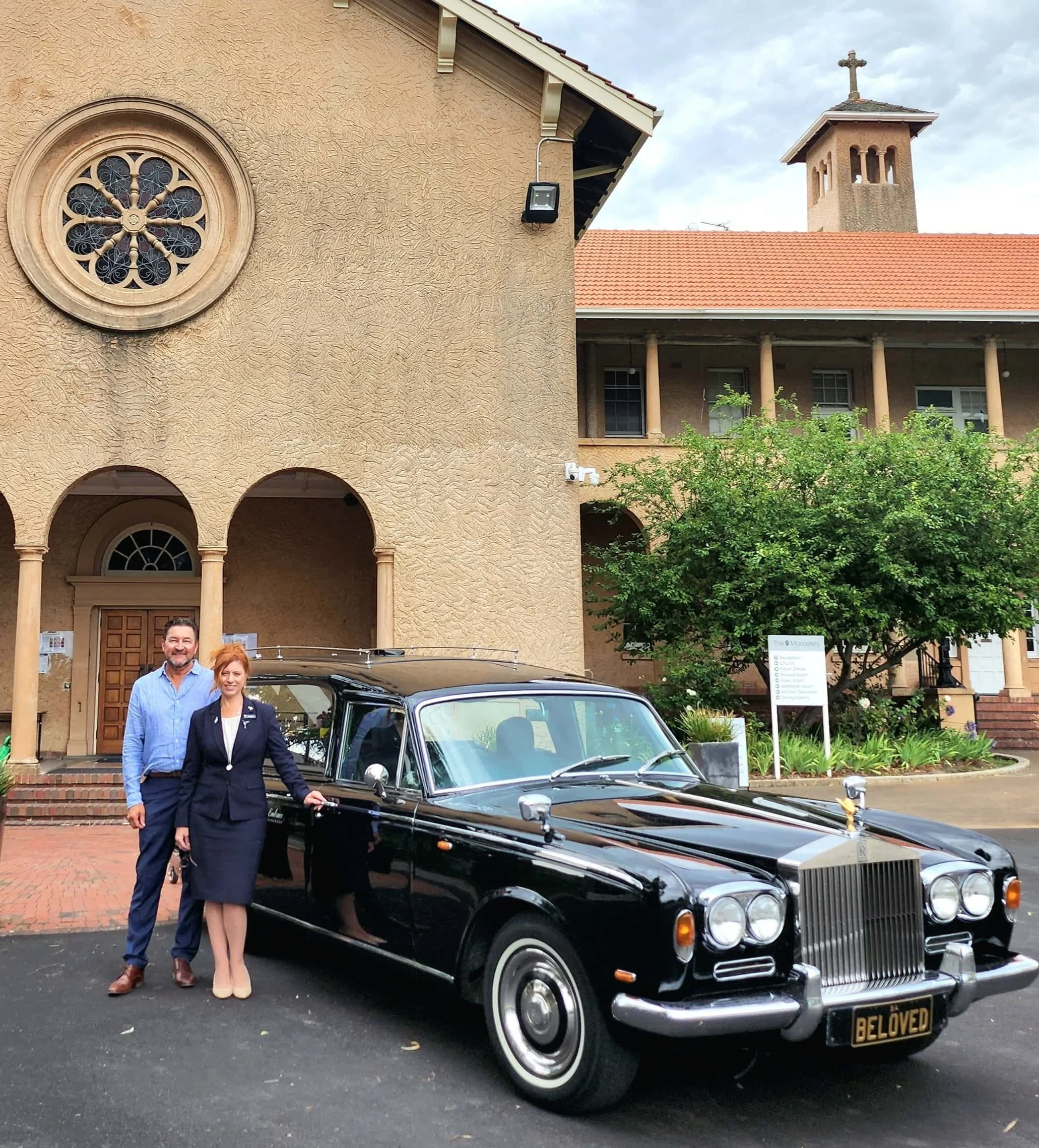 Embrace Funerals staff with the vintage Rolls Royce hearse outside an Adelaide chapel