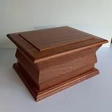 Wooden pedestal or display stand with a rectangular shape and a tiered base.